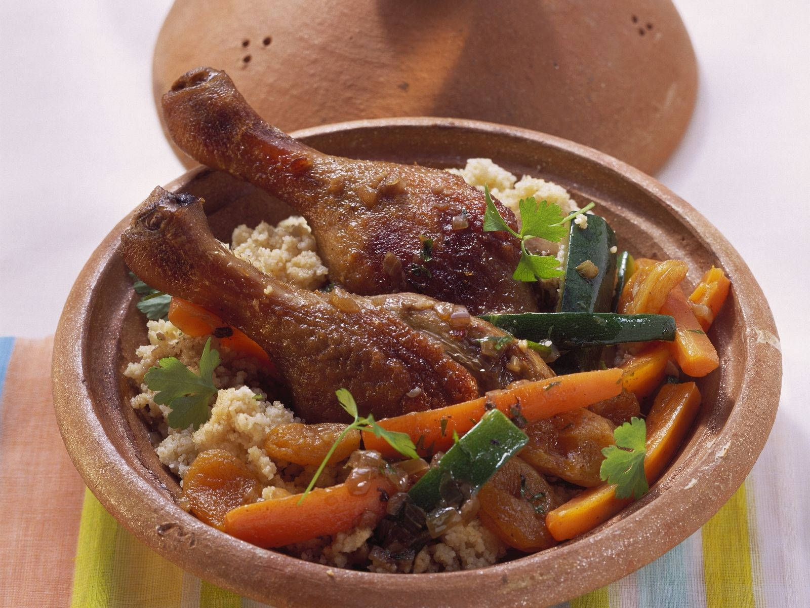 A Delicious Chicken Drumstick Tajine Dish On Table Background