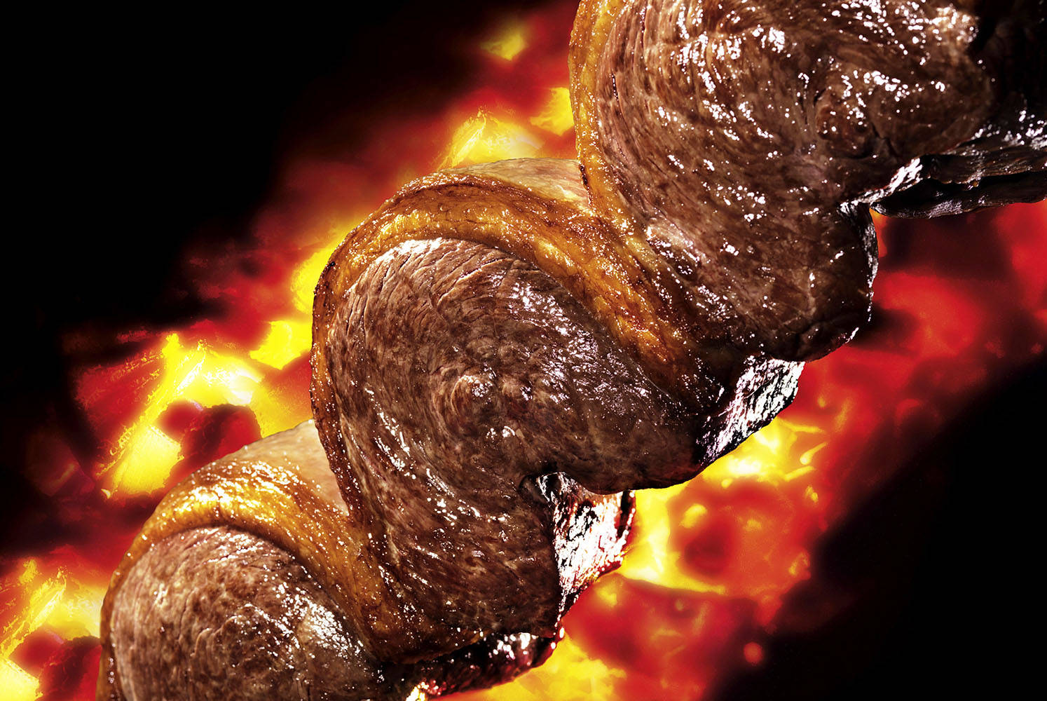 A Delightful Close-up View Of Churrasco Grilling Background