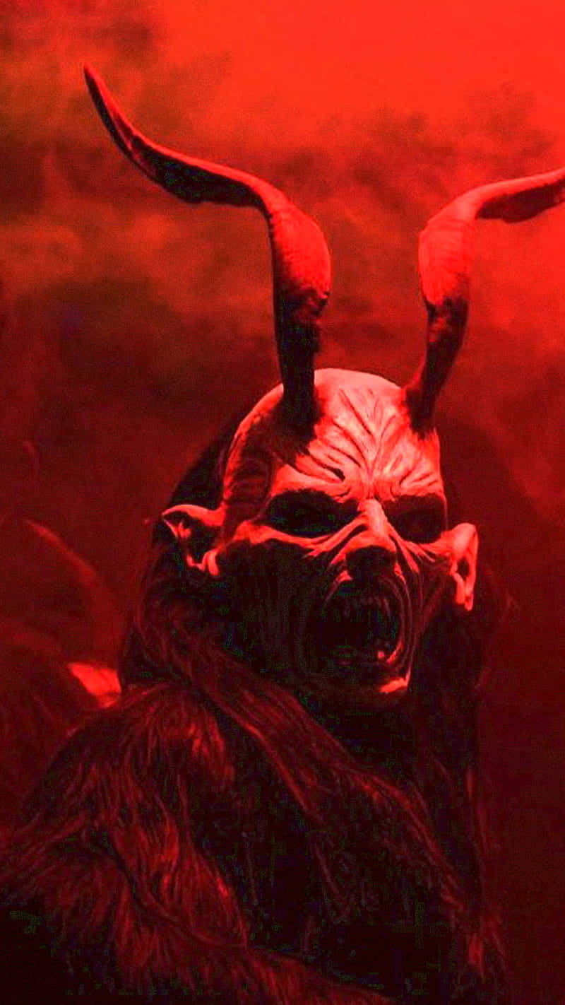 A Demon With Horns In The Red Sky Background