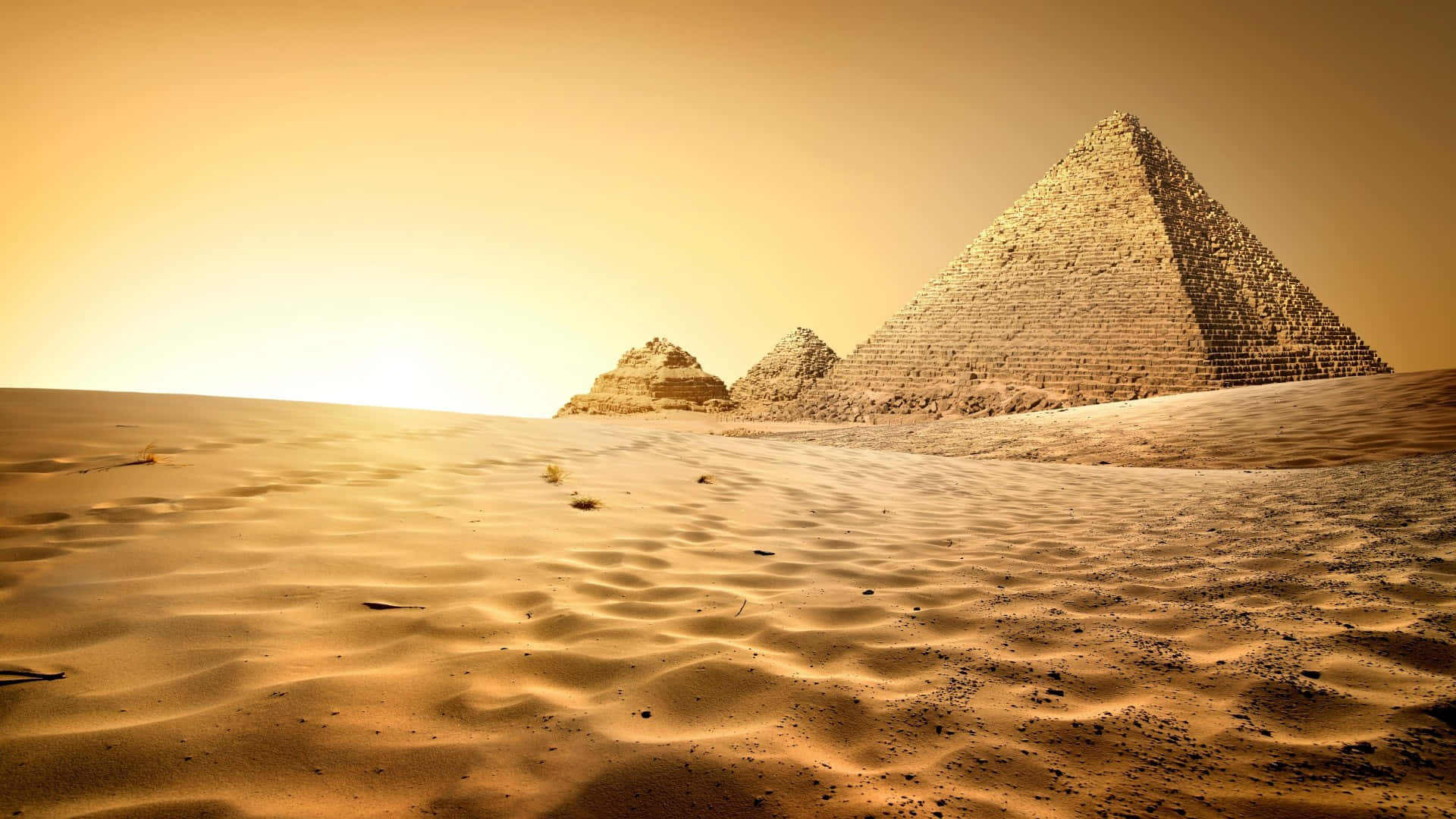A Desert With Pyramids And Sand