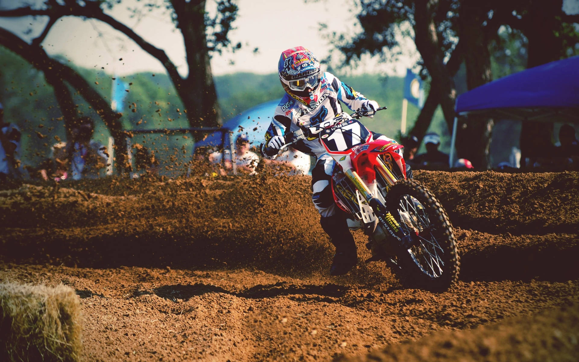 A Dirt Bike Rider Is Riding A Dirt Bike Background