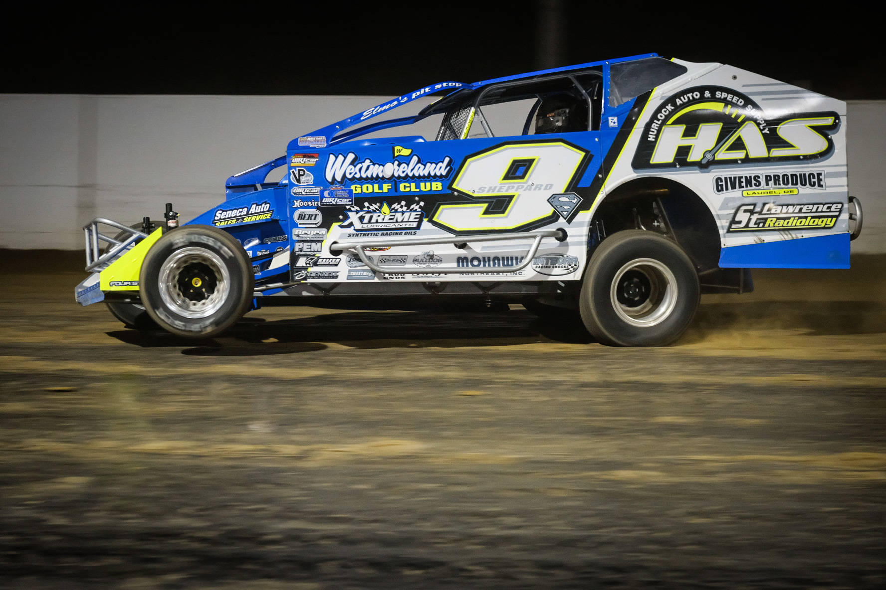 A Dirt Dirt Car Driving On A Dirt Track Background