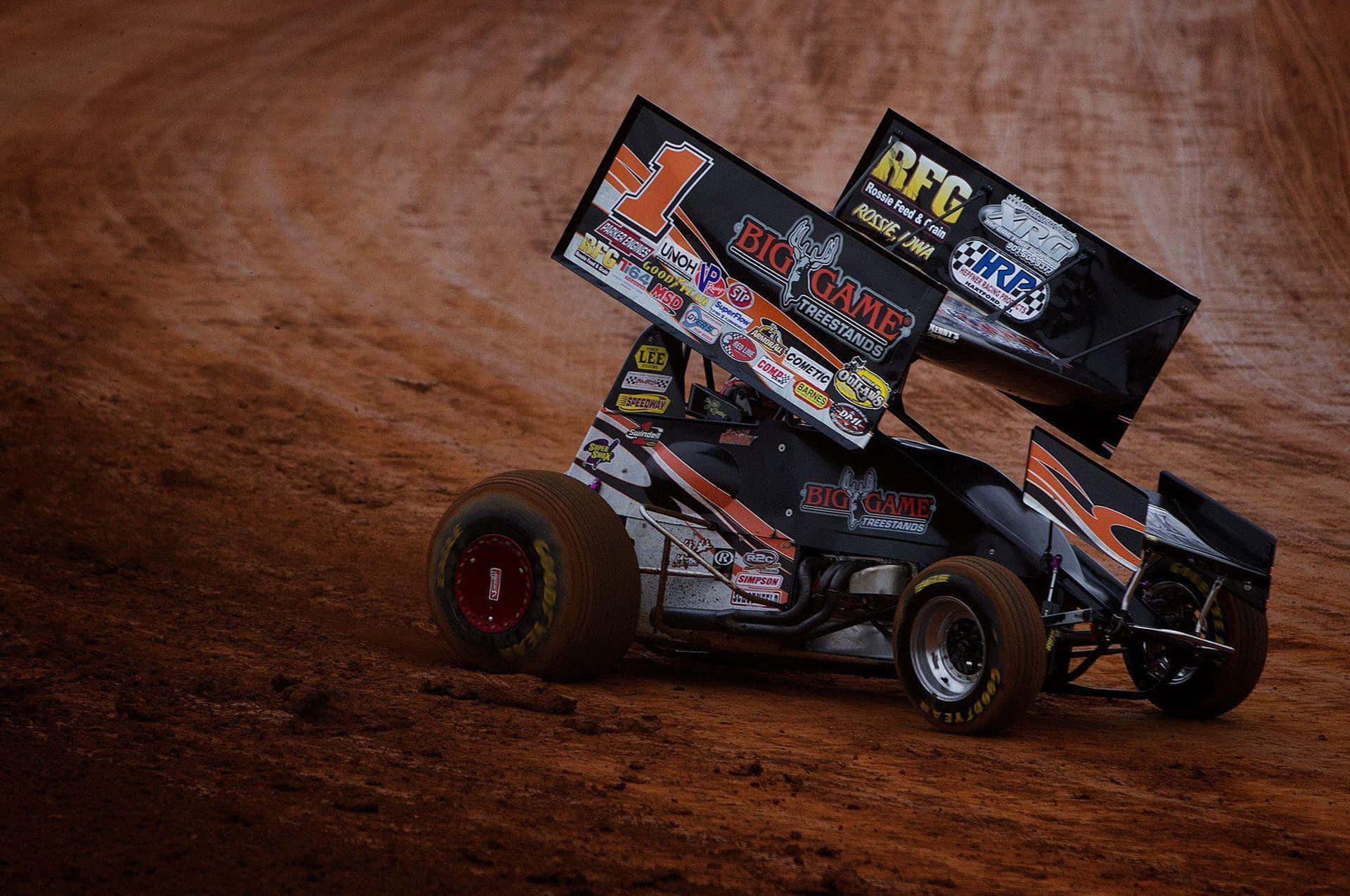 A Dirt Track Race Car Driving Down A Dirt Track Background