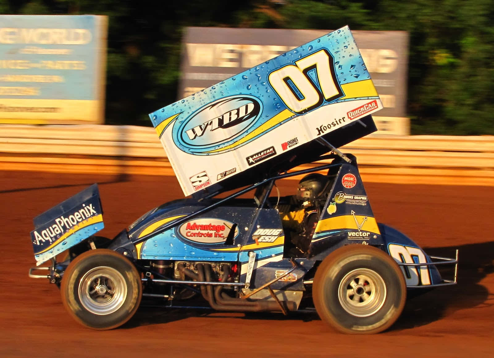 A Dirt Track Race Car Driving Down The Track Background