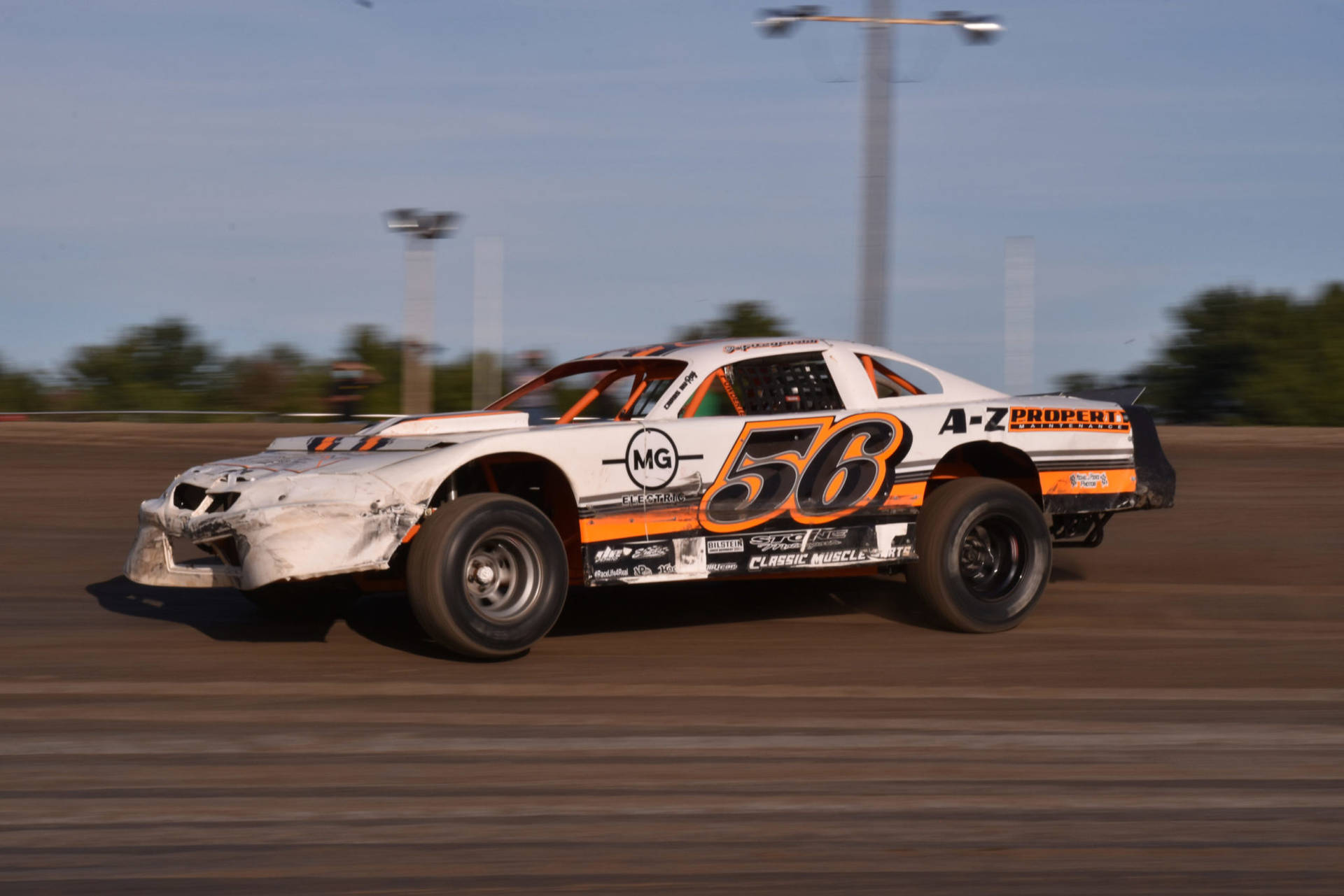 A Dirt Track With A Race Car Background