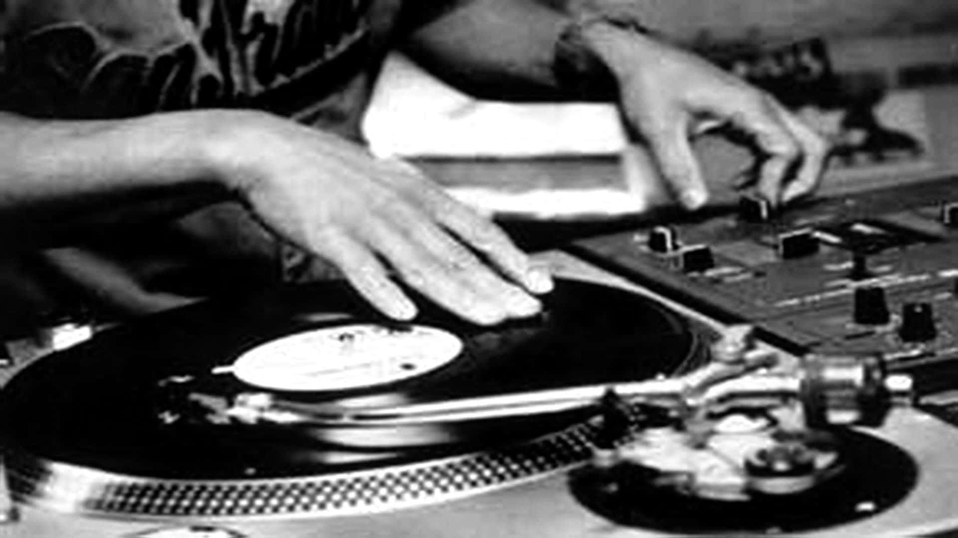 A Dj Is Mixing On A Turntable Background