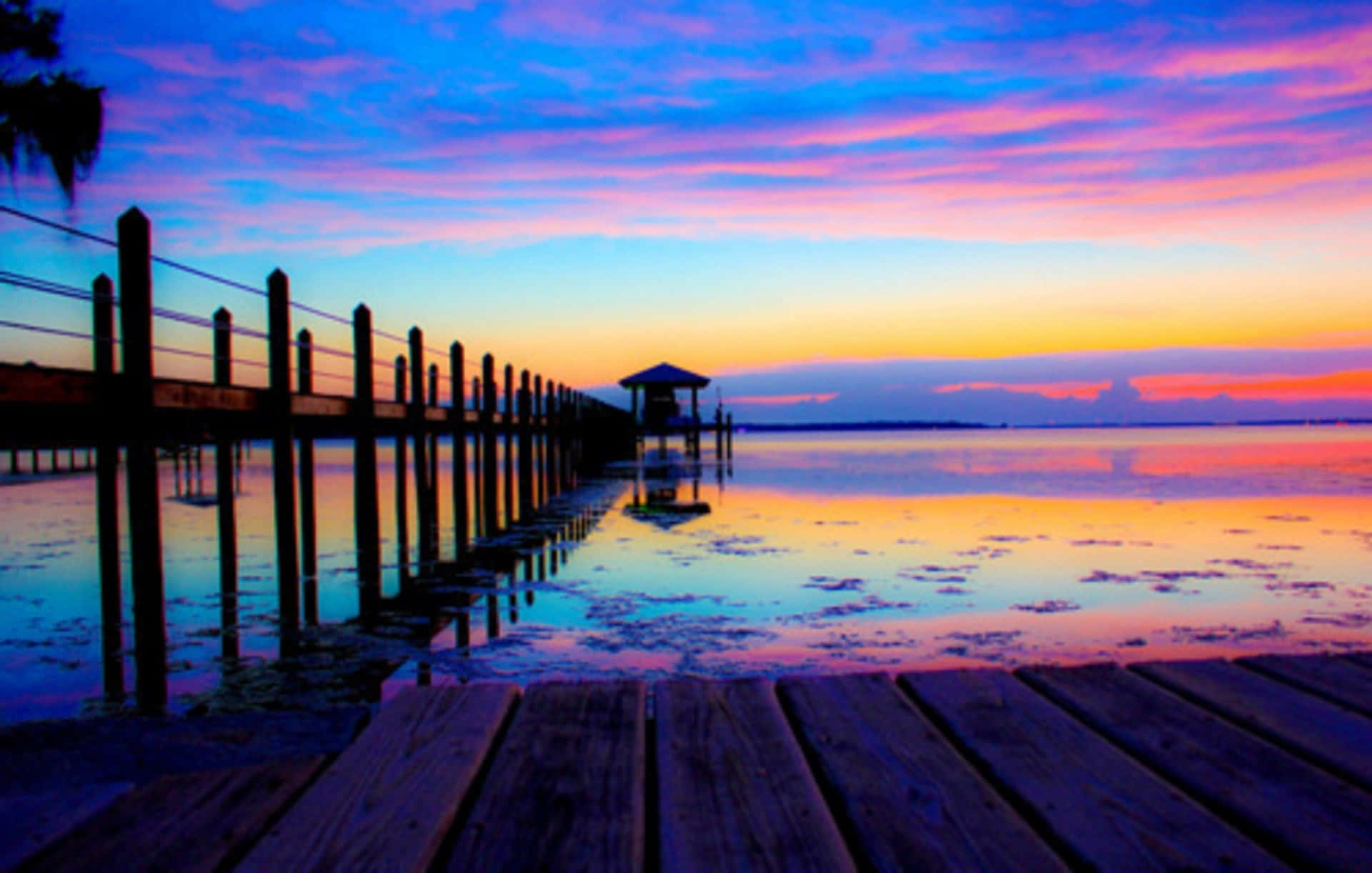 A Dock With A Colorful Sunset