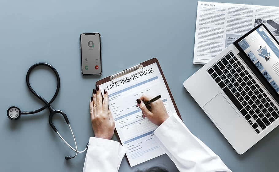 A Doctor Is Writing A Life Insurance Form On A Clipboard Background