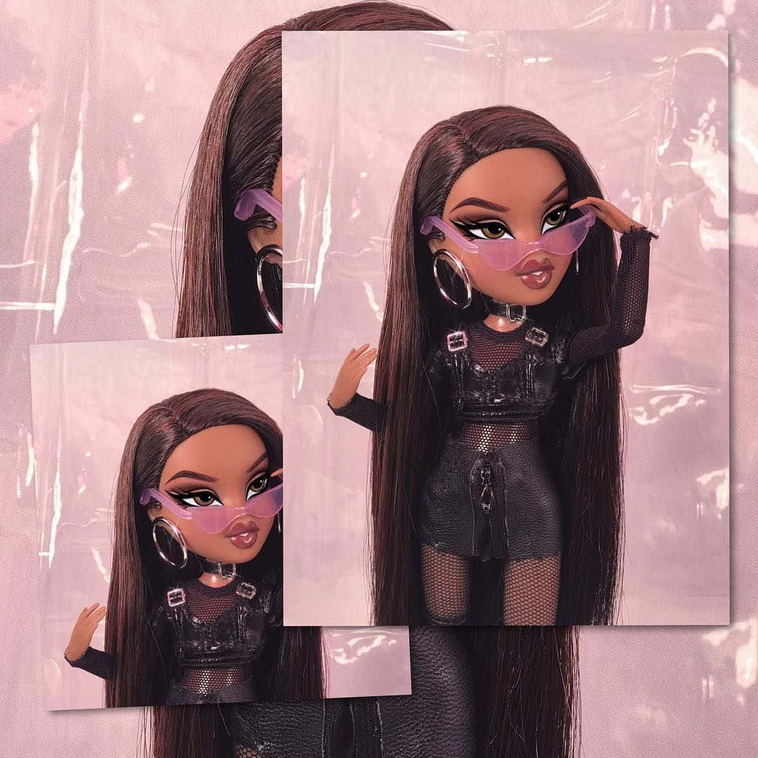 A Doll With Long Hair And Glasses