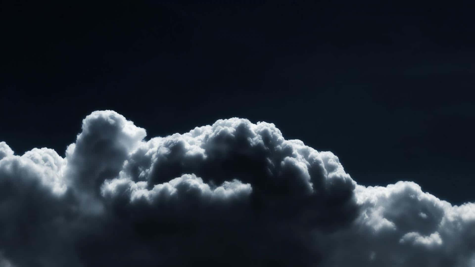 A Dramatic View Of Low-hanging Clouds Against A Black And White Sky. Background