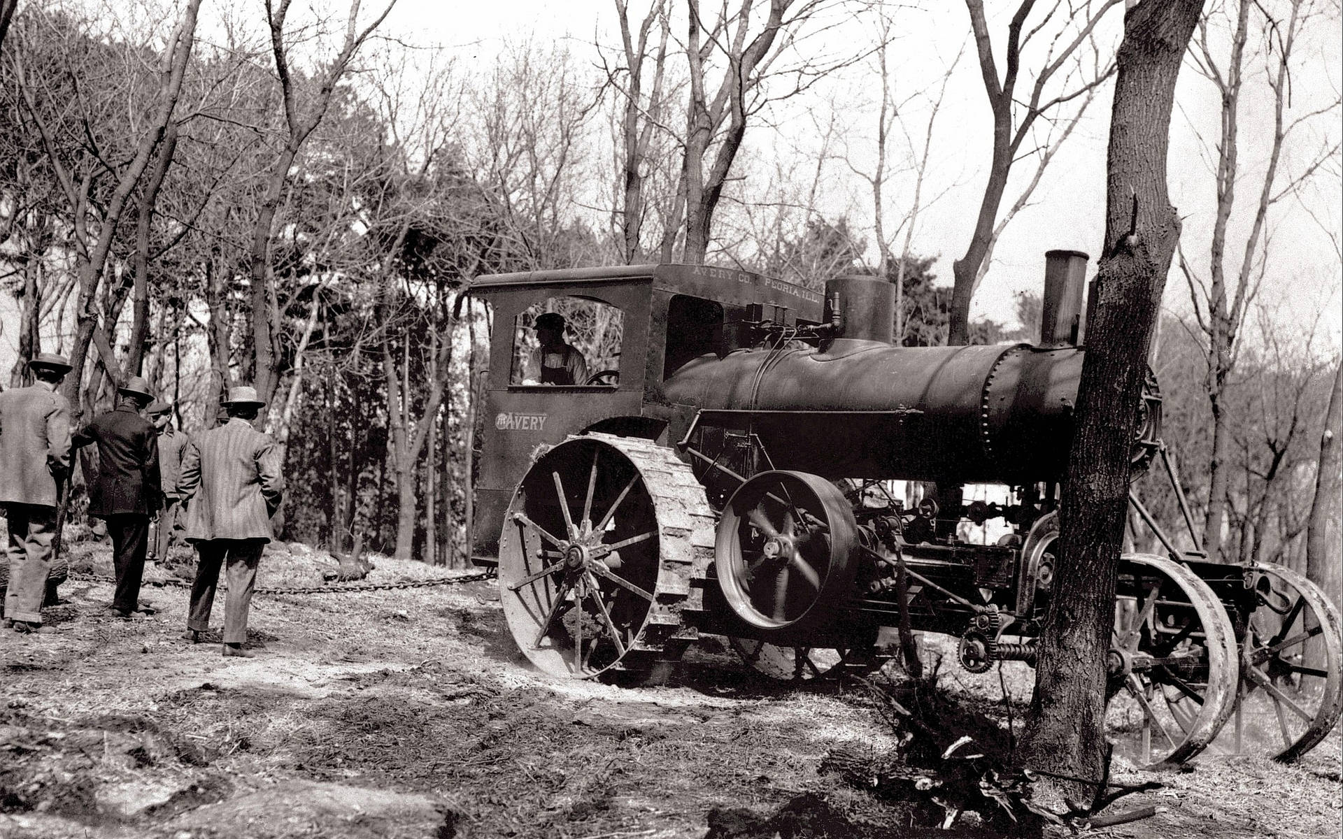 A Duo And Their Trusty Vintage Steam Tractor Background