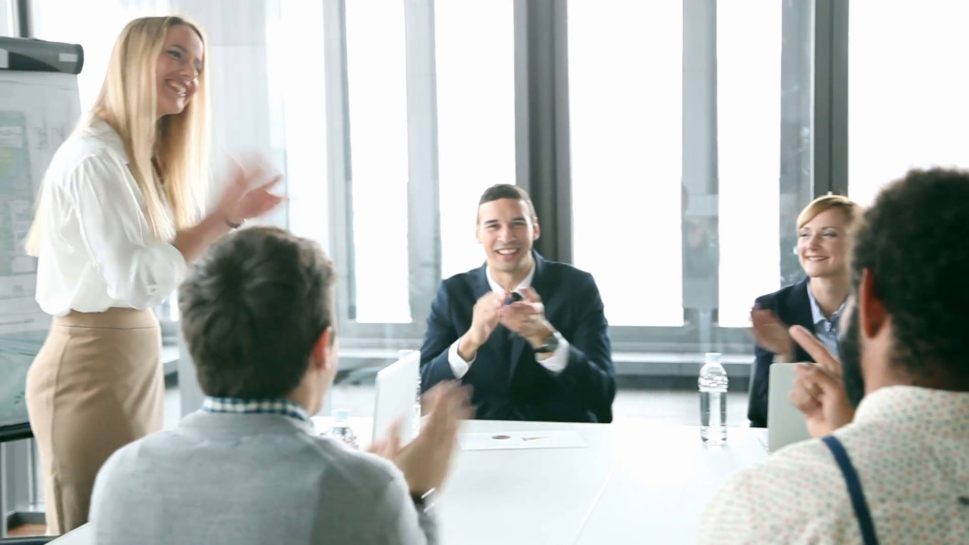 A Dynamic Team Meeting With Woman Leading The Presentation