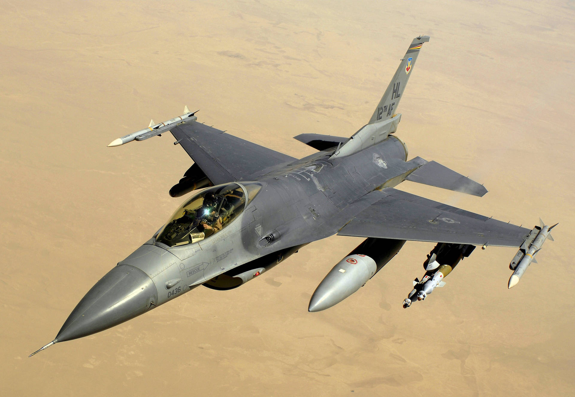 A F-16 Fighter Jet Flying In The Sky Background