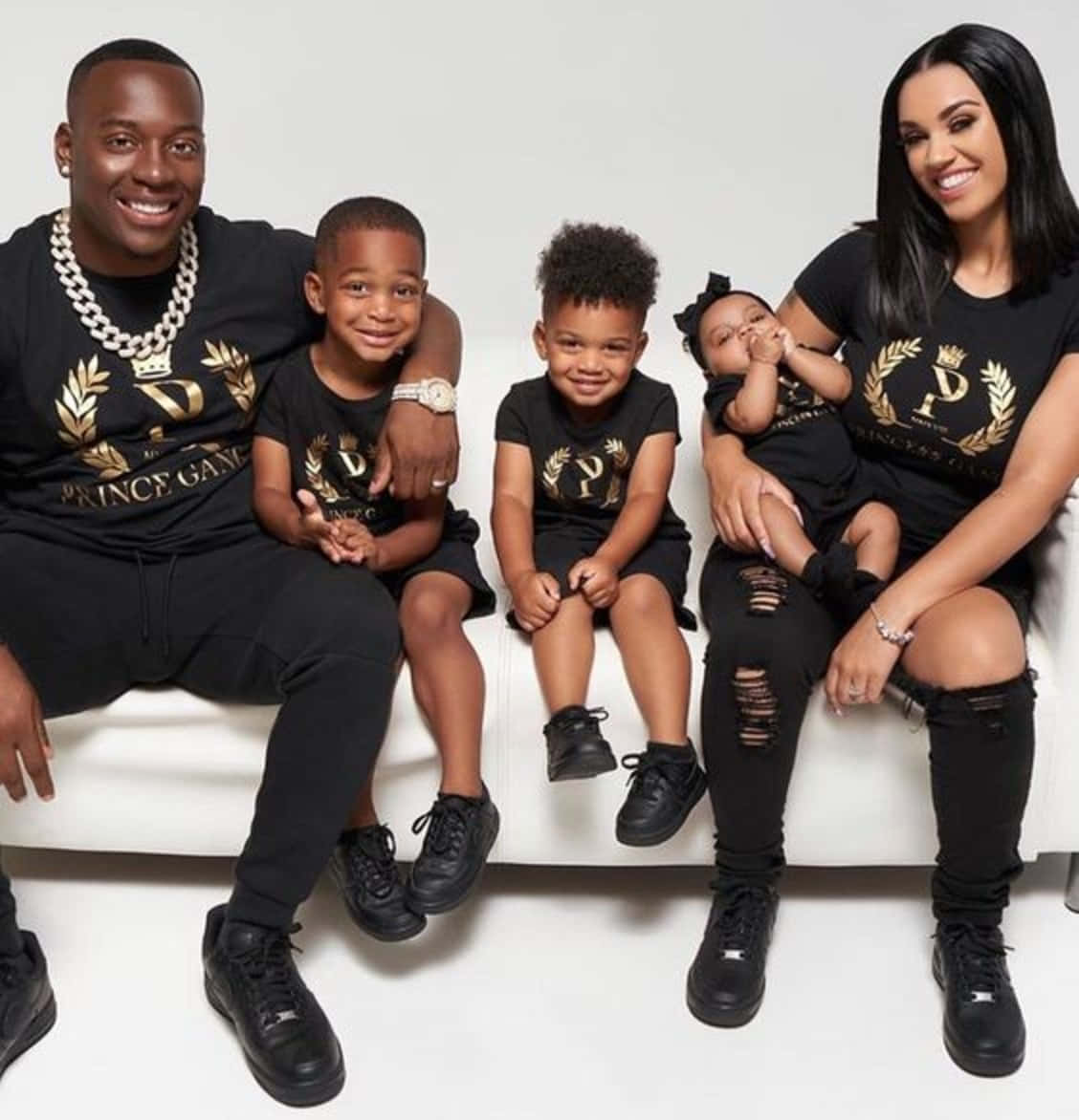 A Family Of Four Wearing Black T - Shirts Background