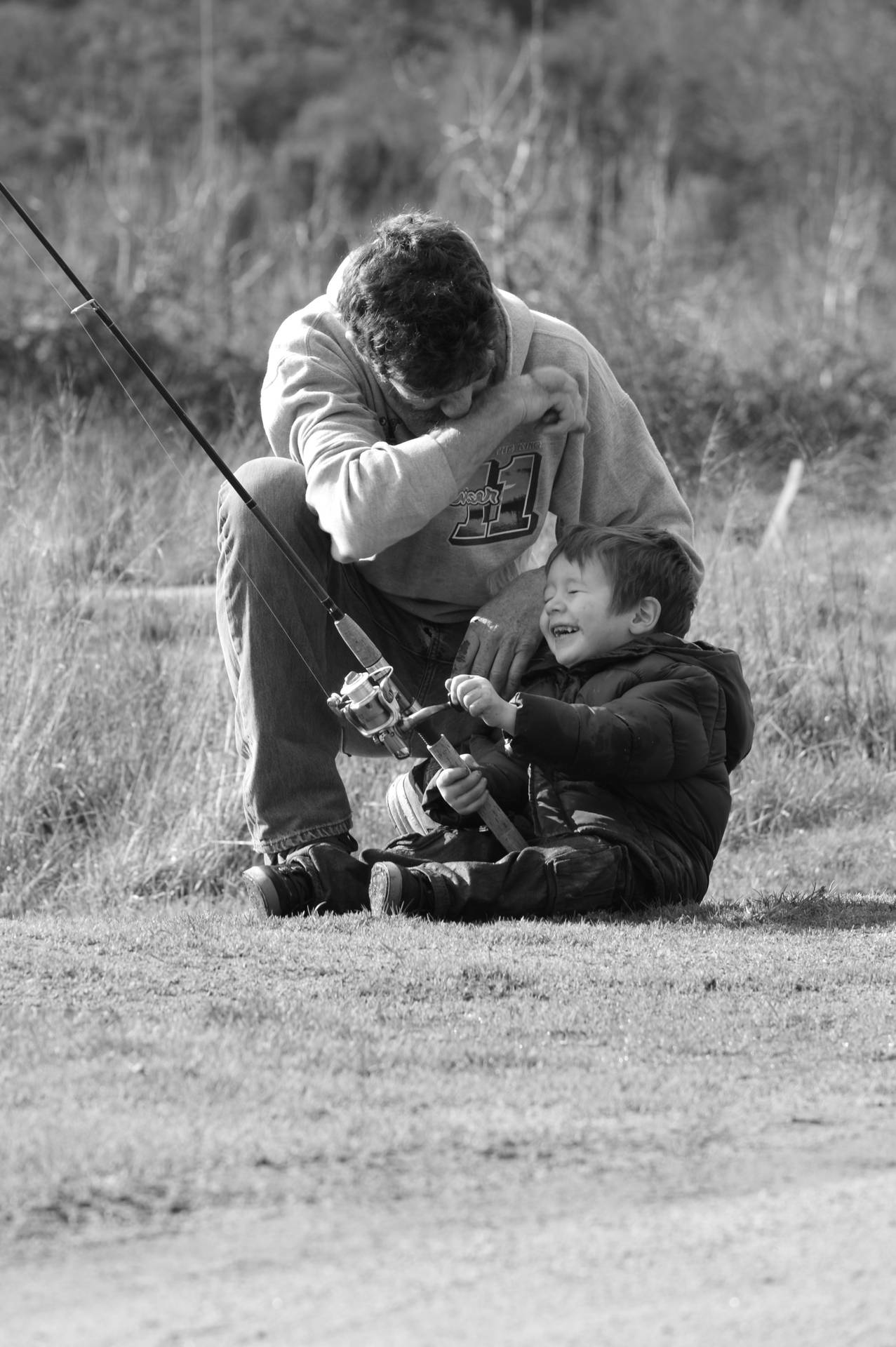 A Father And Son Bonding Over A Shared Fishing Experience. Background