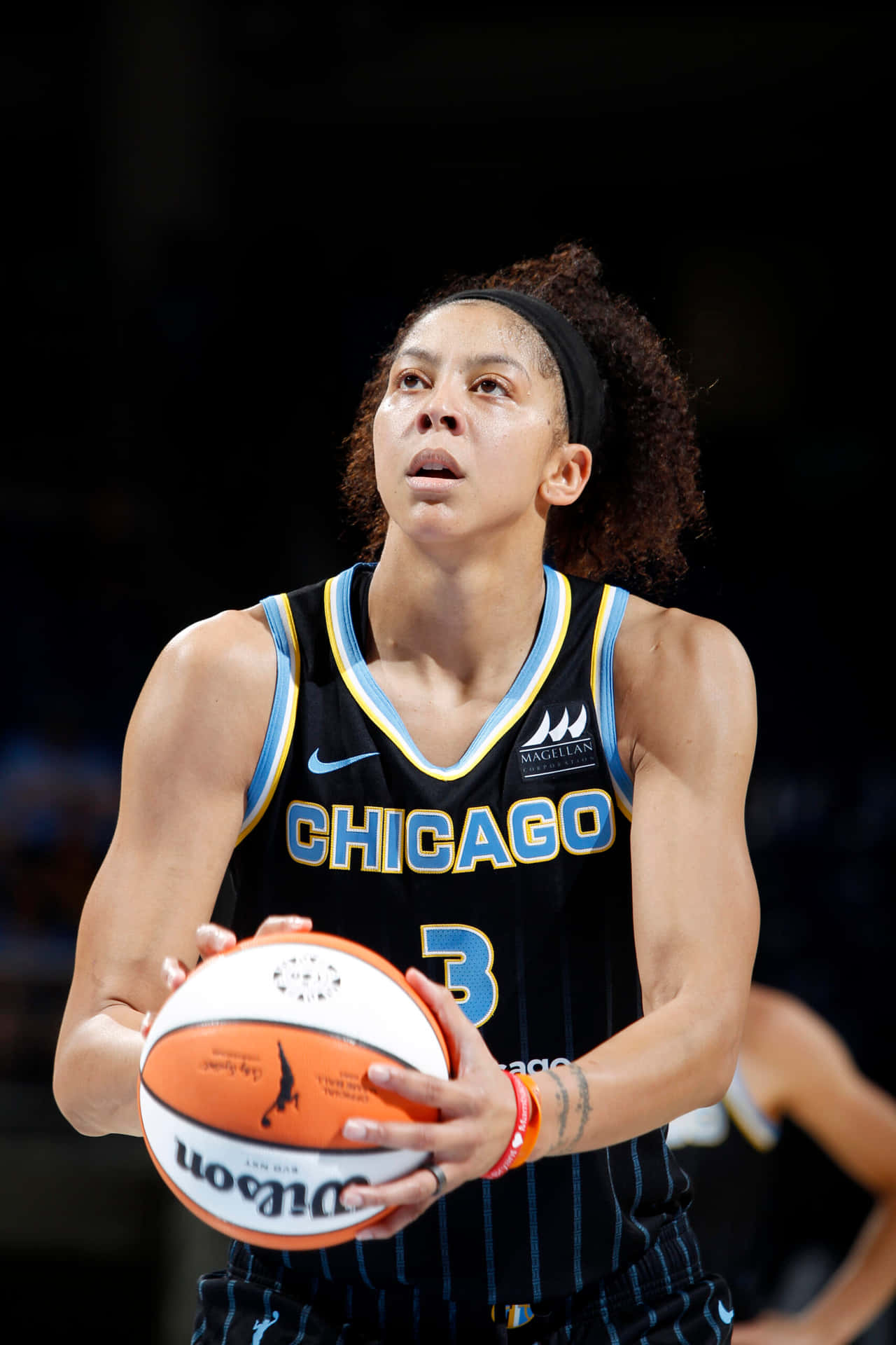 A Female Basketball Player Holding A Ball Background