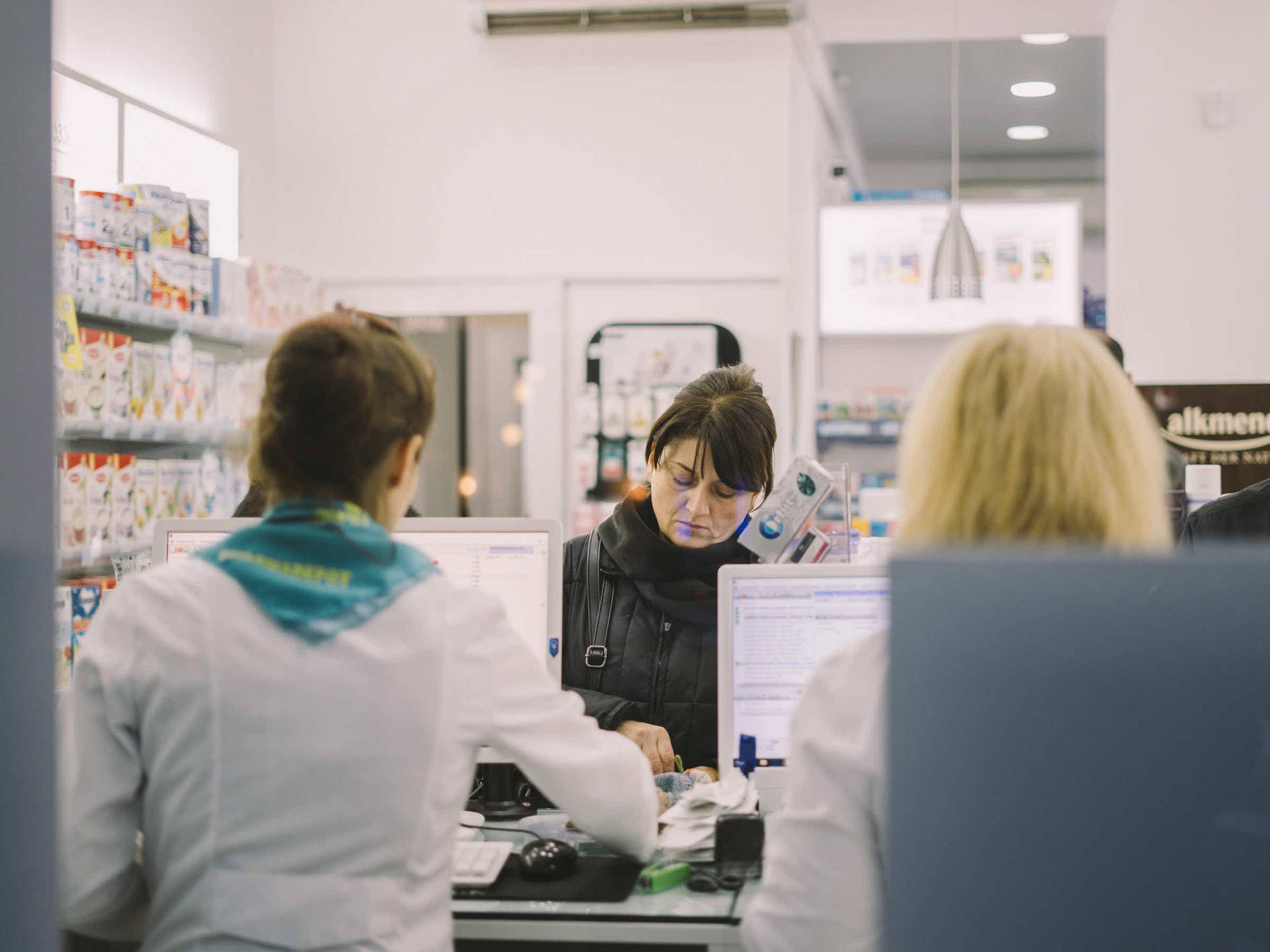 A Female Customer Purchasing From Pharmacist Background