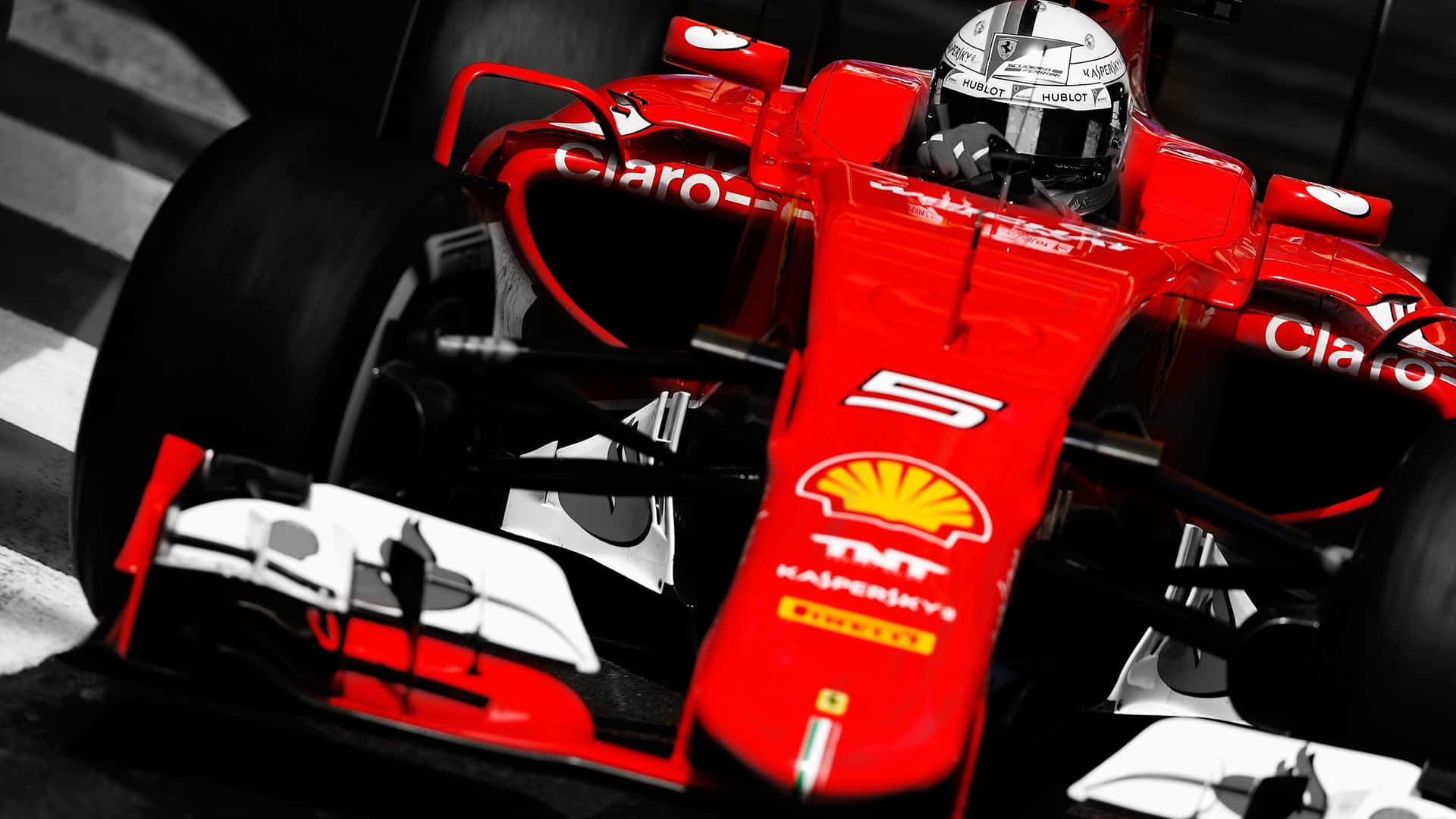 A Ferrari F1 Race Car Cruises Around A Track Background