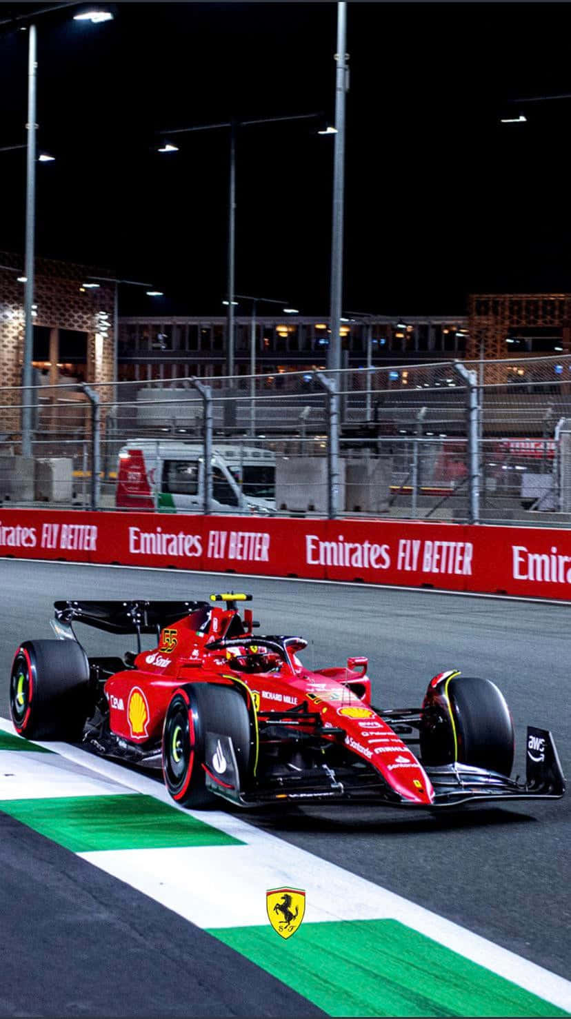 A Ferrari Racing Car Driving On A Track At Night Background