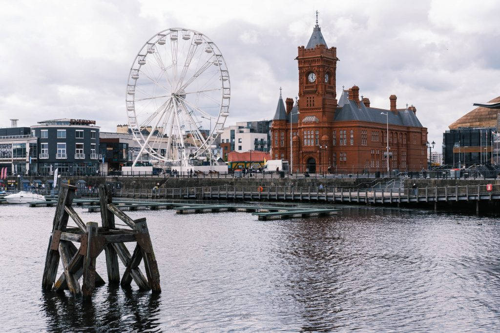 A Ferris Wheel And A Building In The Water