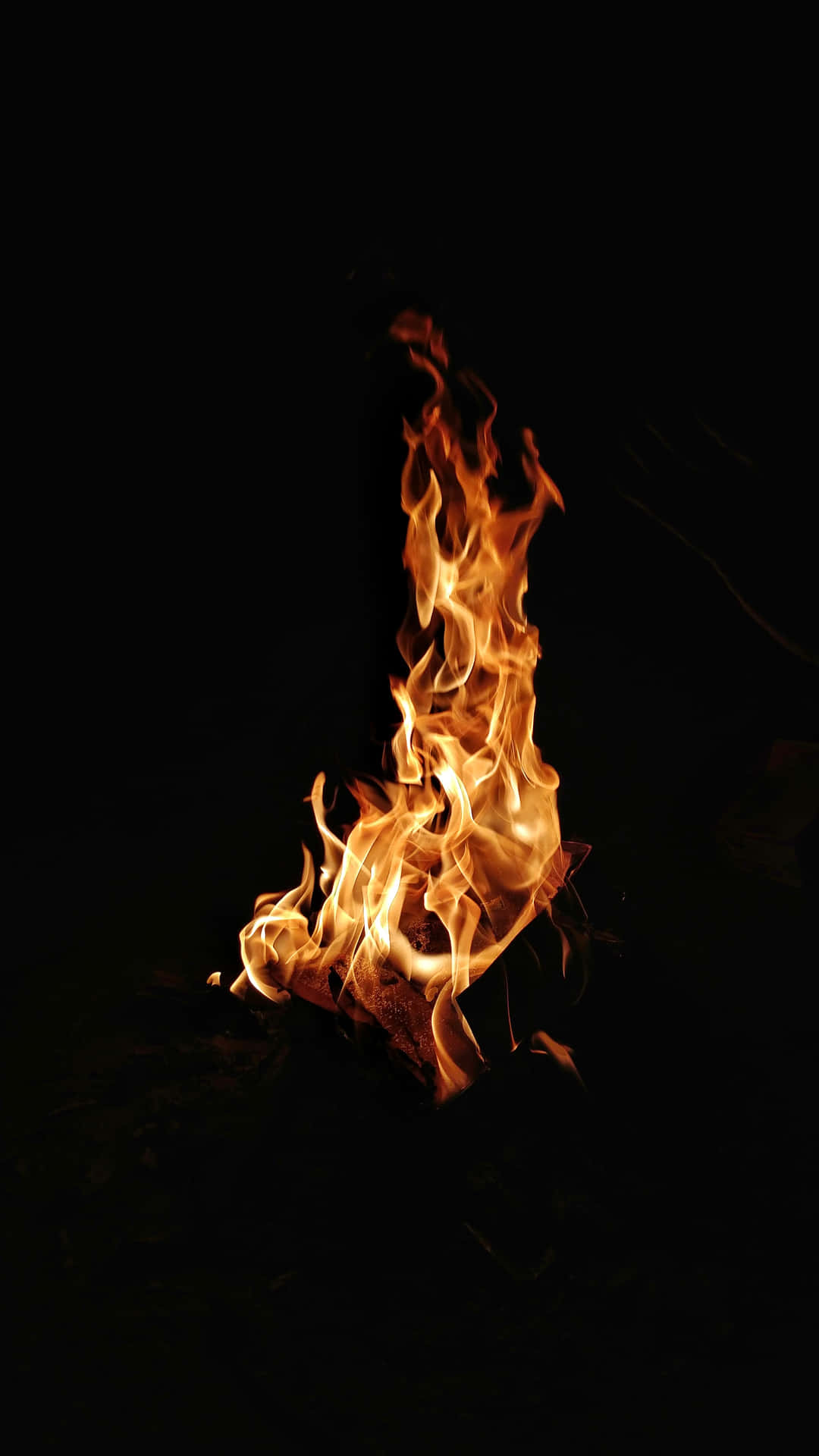 A Fire Burning In The Dark Background