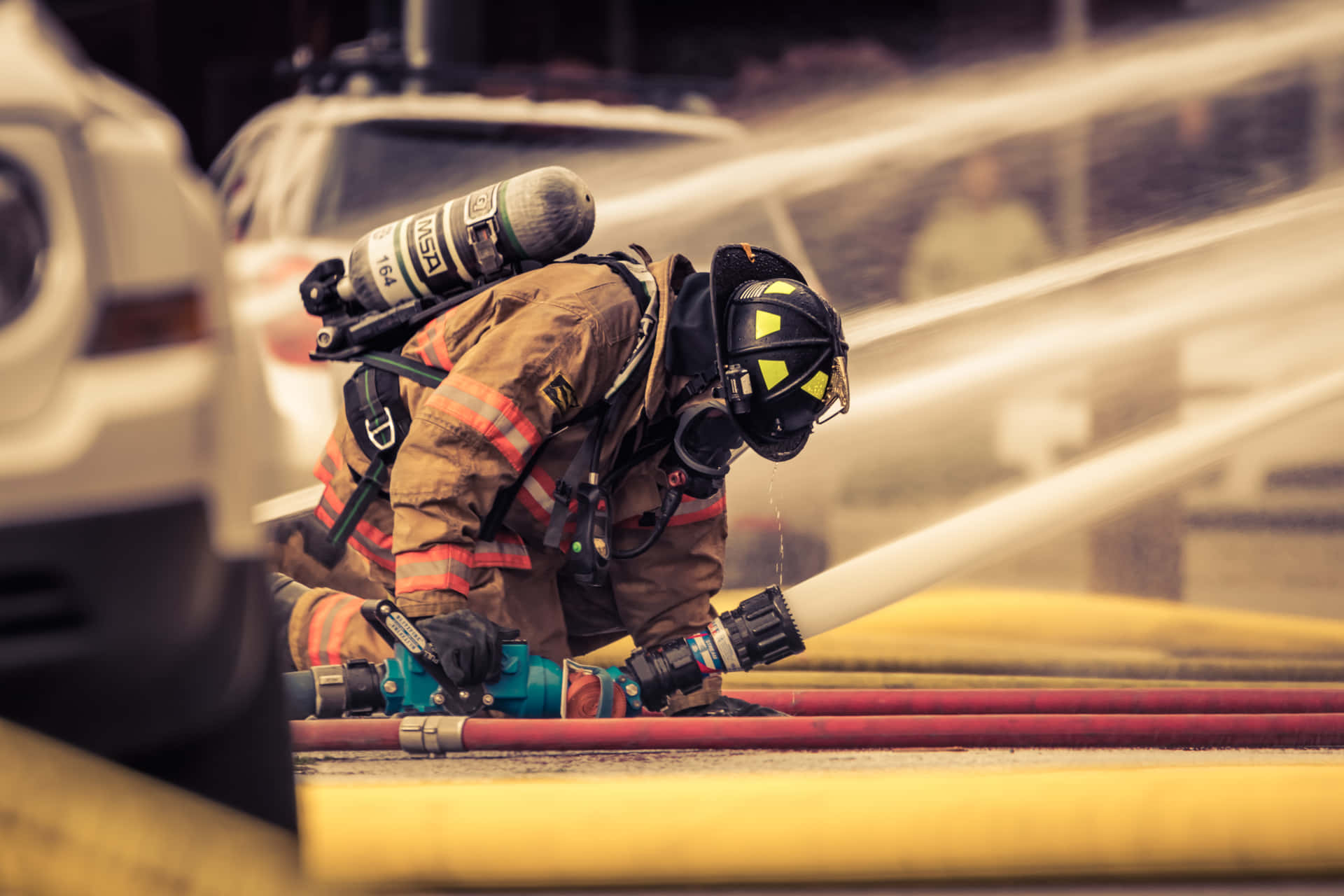 A Firefighter Is Spraying Water Background