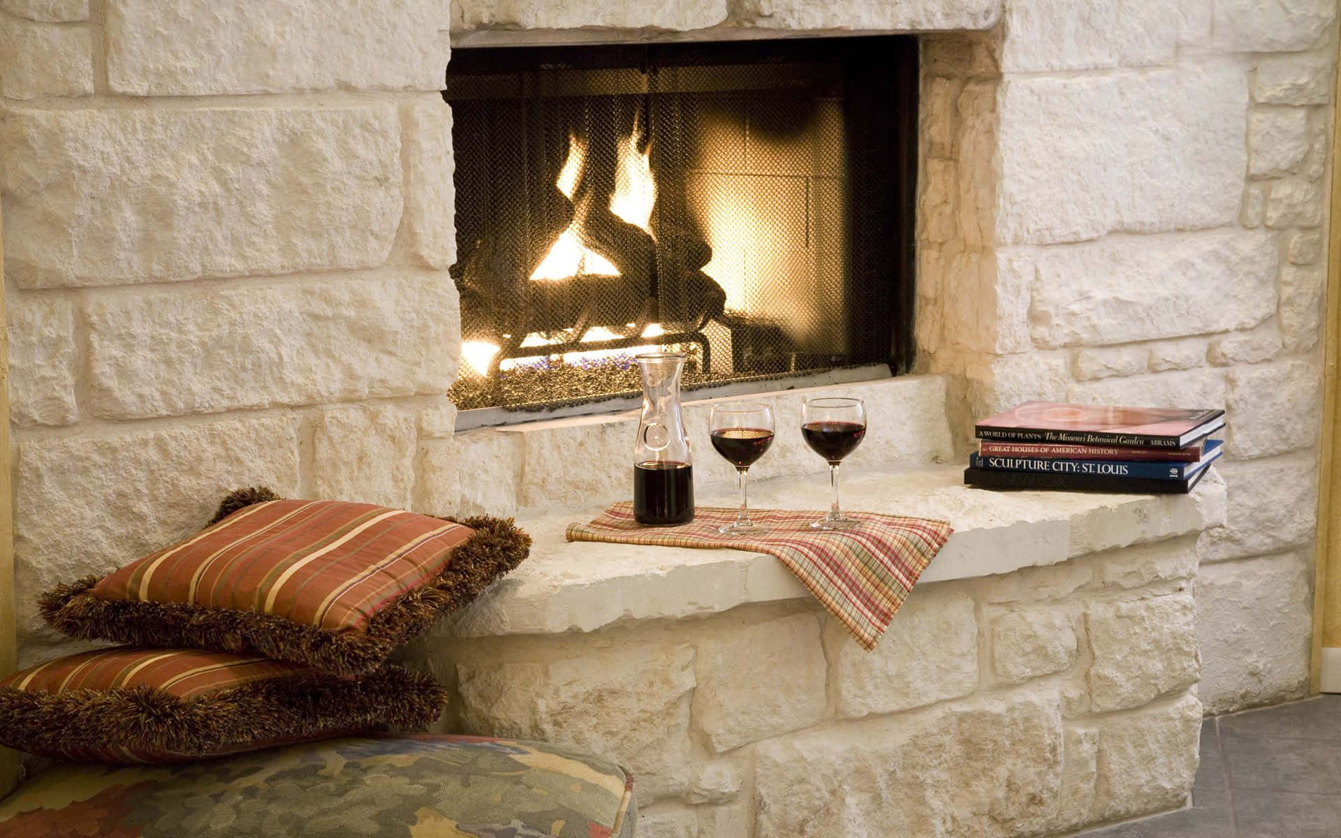 A Fireplace With A Book And Wine Background