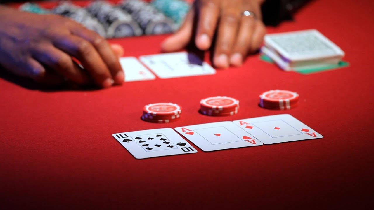 A Five-card Draw Game In Action With Red Poker Chips Background