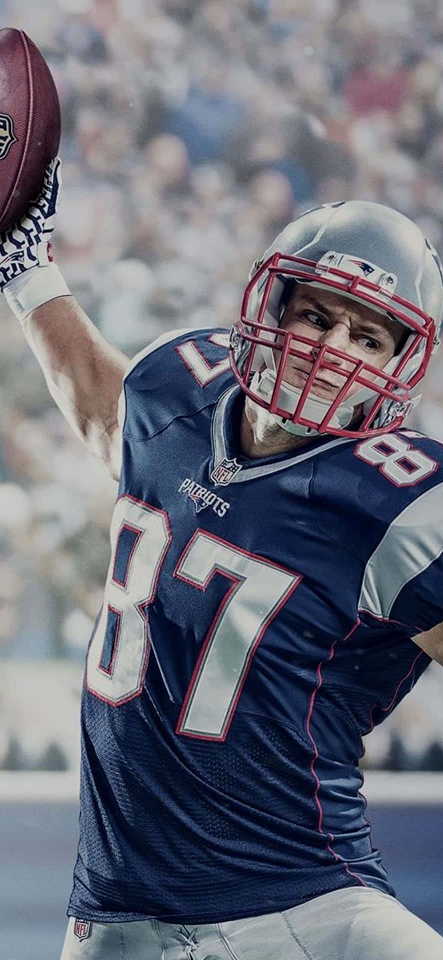 A Football Player Is Holding A Football Background