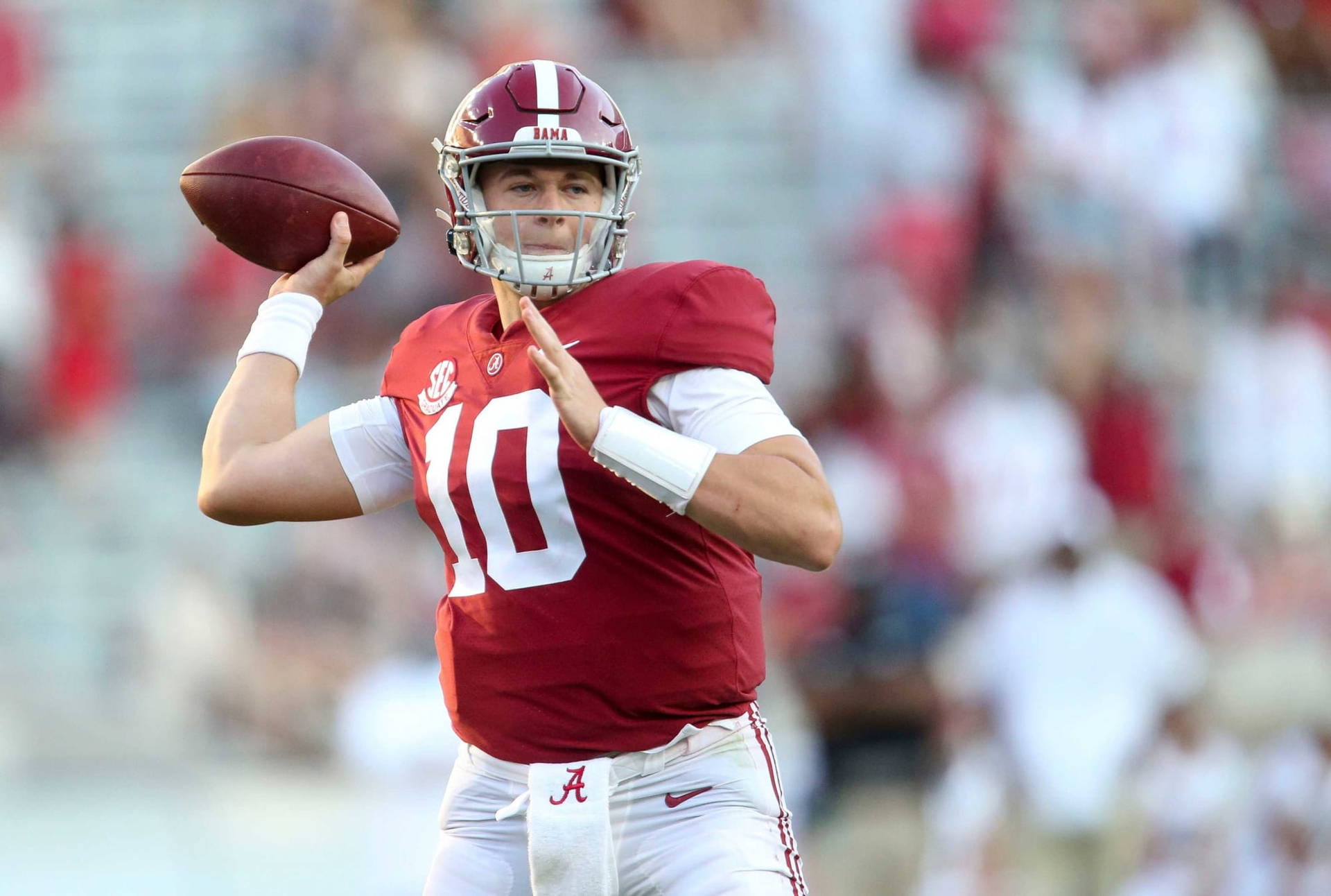 A Football Player Is Throwing A Ball