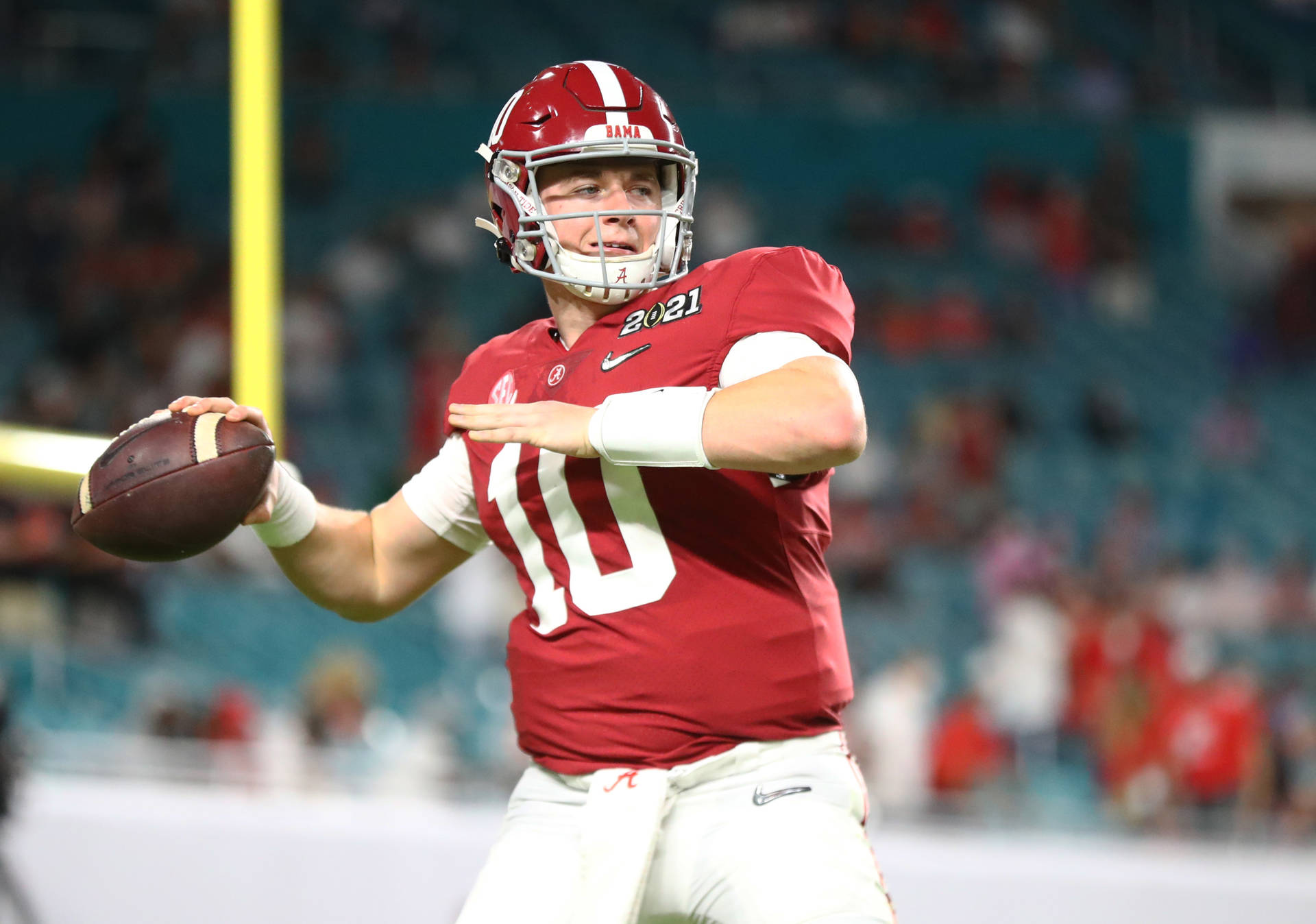 A Football Player Is Throwing A Ball