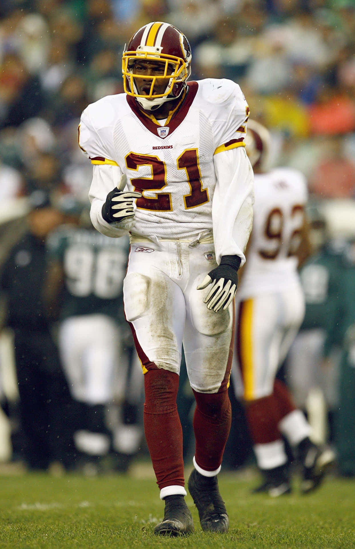 A Football Player Is Wearing A White Uniform Background