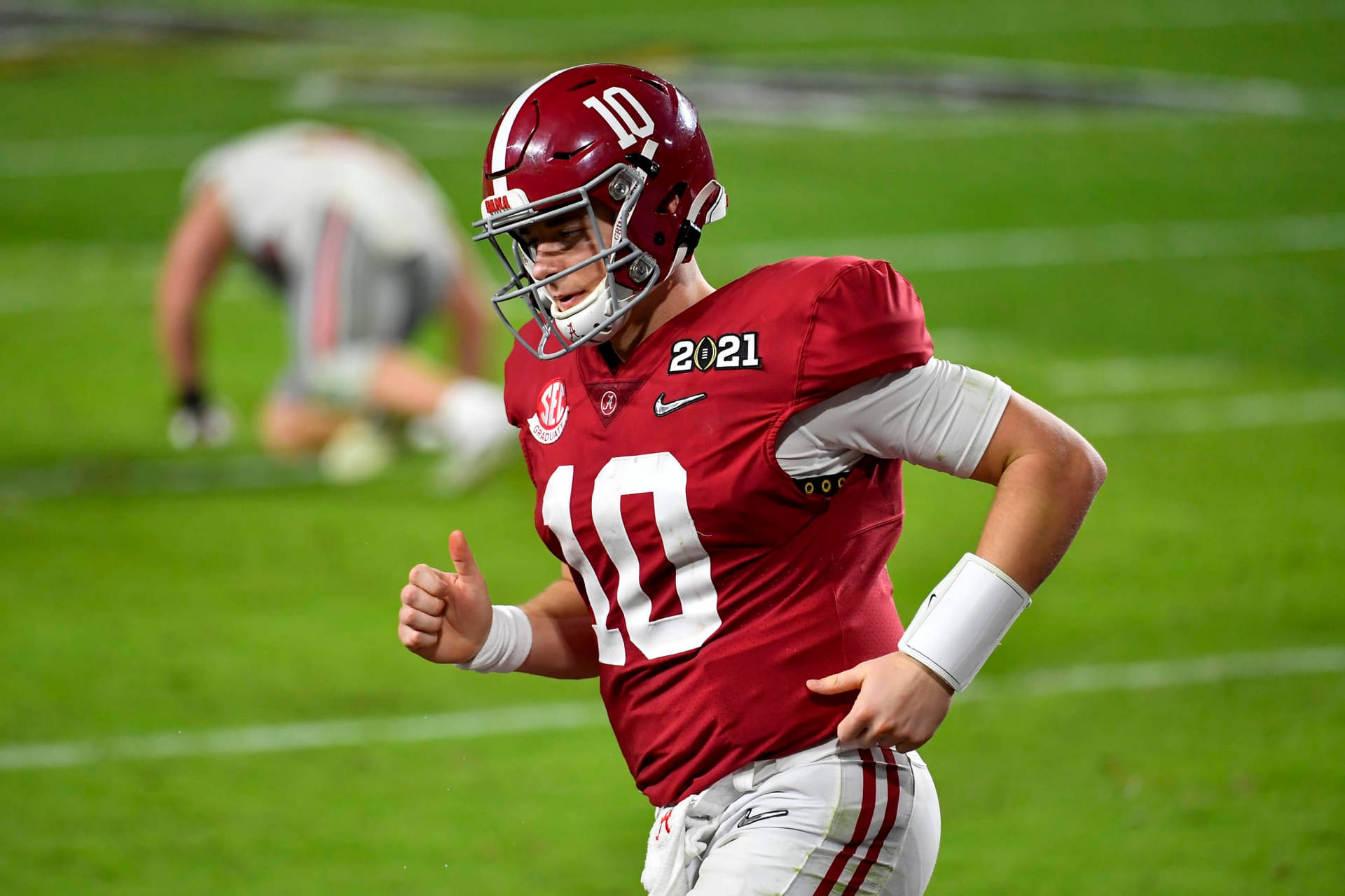 A Football Player Running On A Field Background