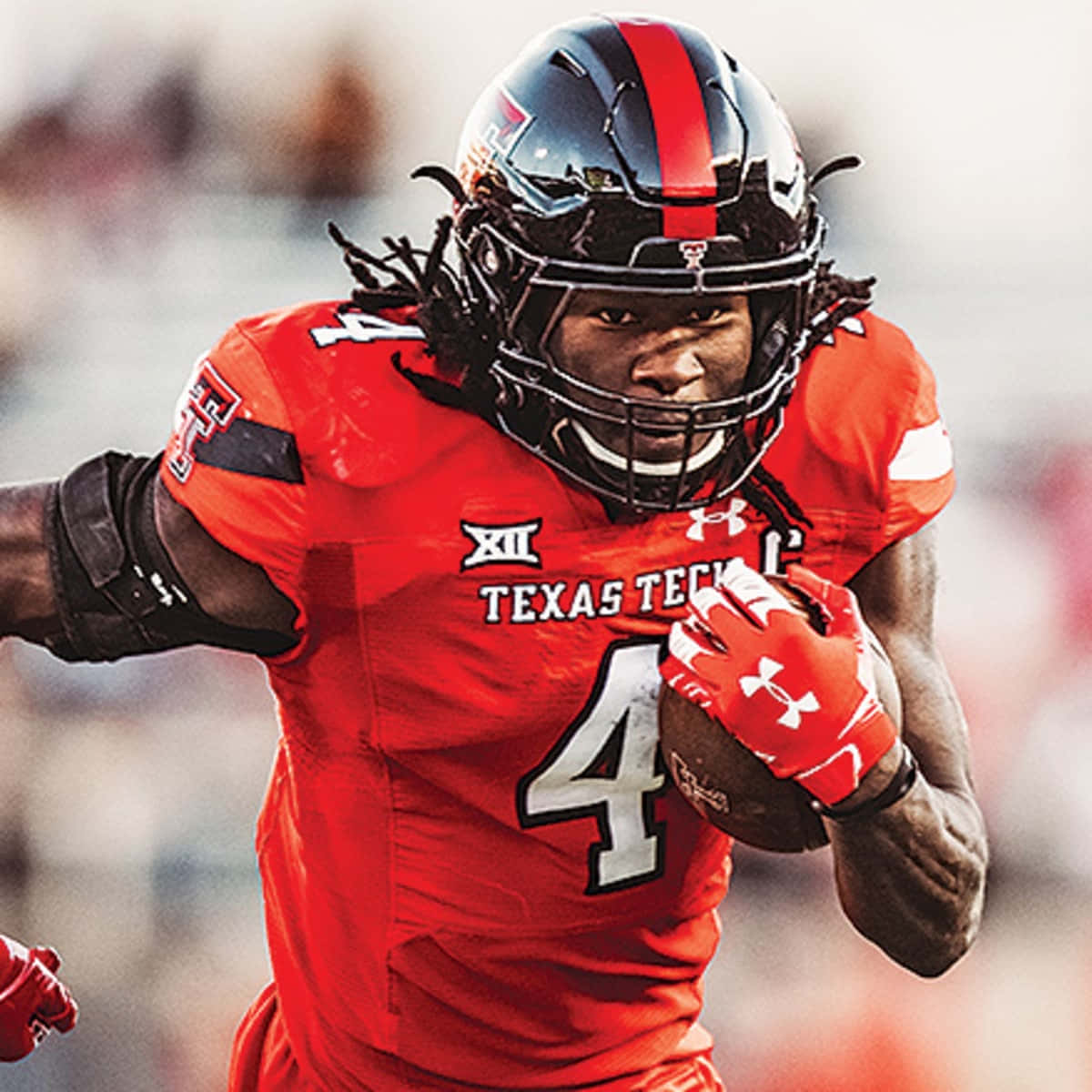 A Football Player Running With A Ball Background