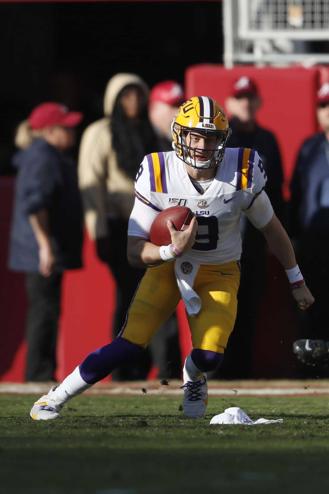 A Football Player Running With The Ball Background