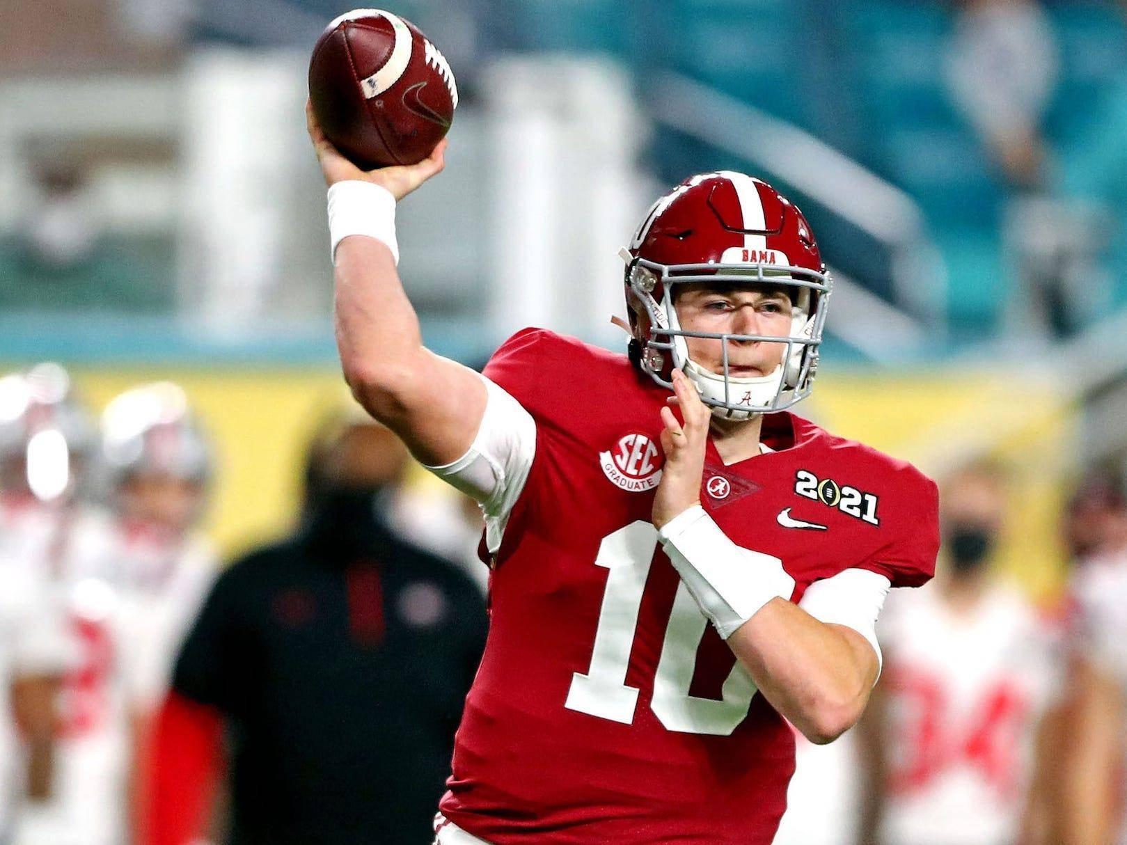 A Football Player Throwing A Ball