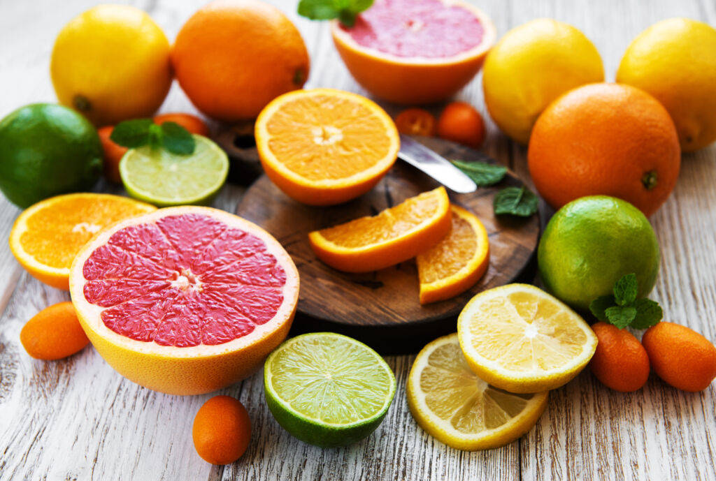 A Fresh Array Of Sour Fruits Being Sliced Background