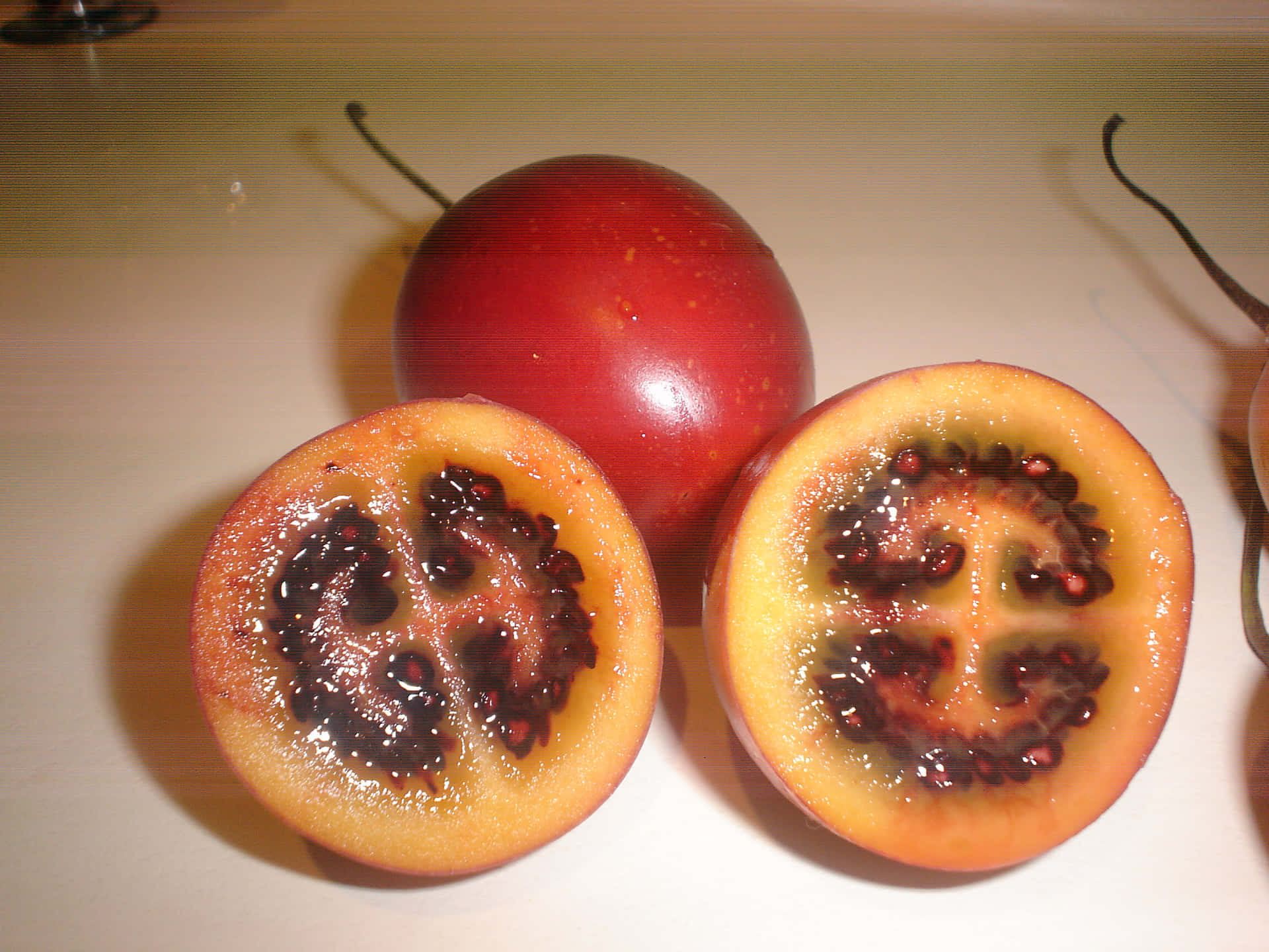 A Fresh Medley Of Sliced And Whole Tamarillos Background