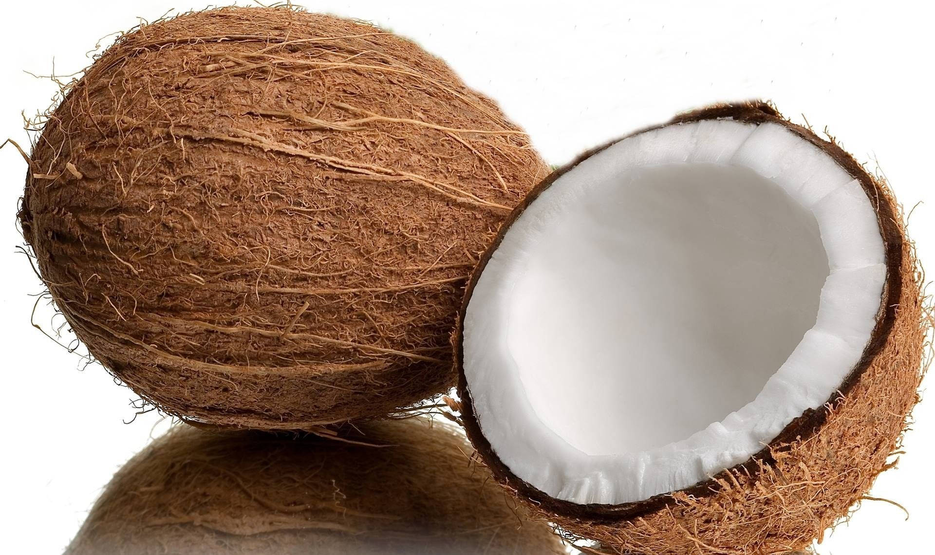 A Fresh Whole Coconut On A Neutral Backdrop