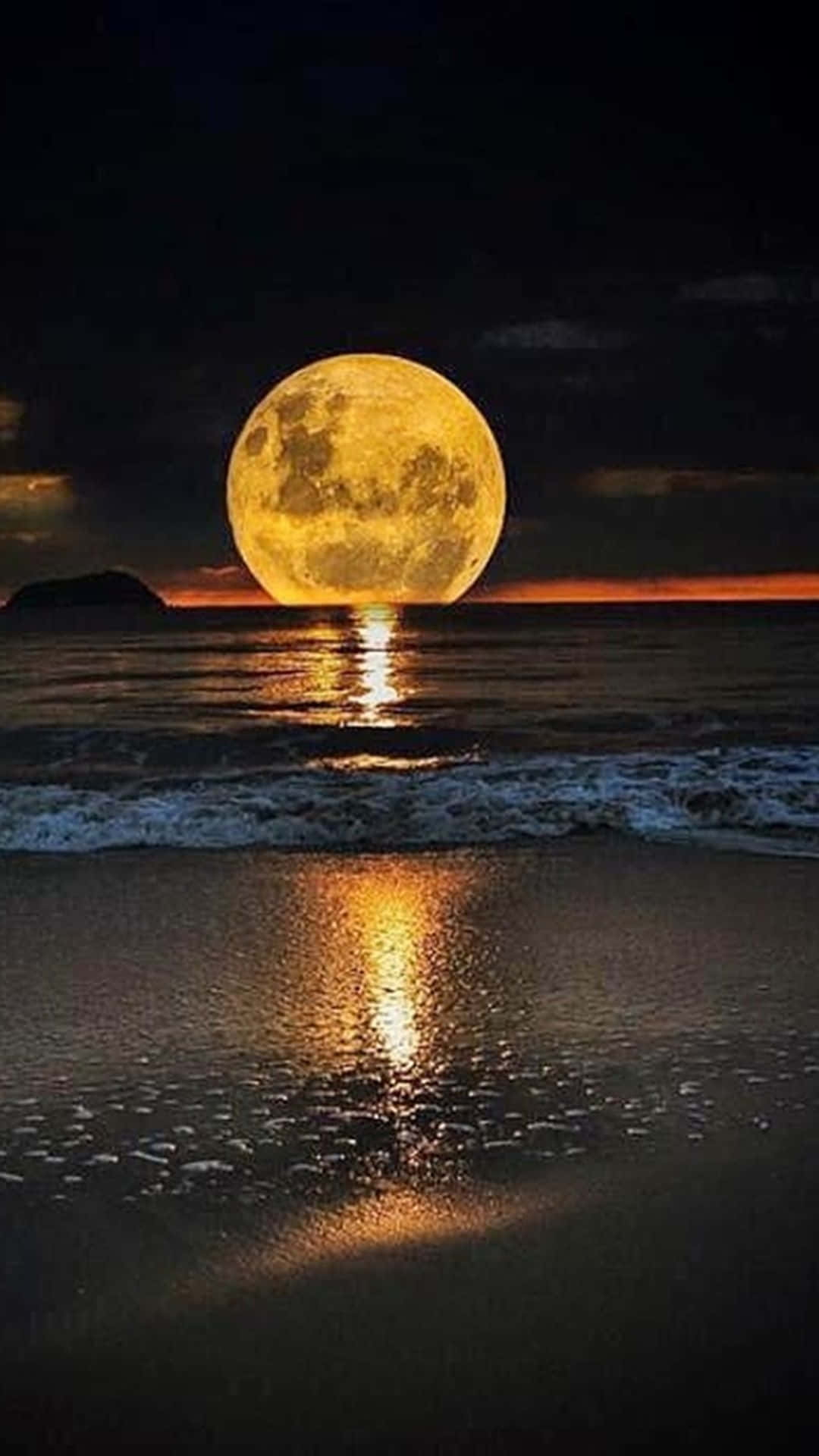 A Full Moon Is Seen Over The Ocean At Night Background