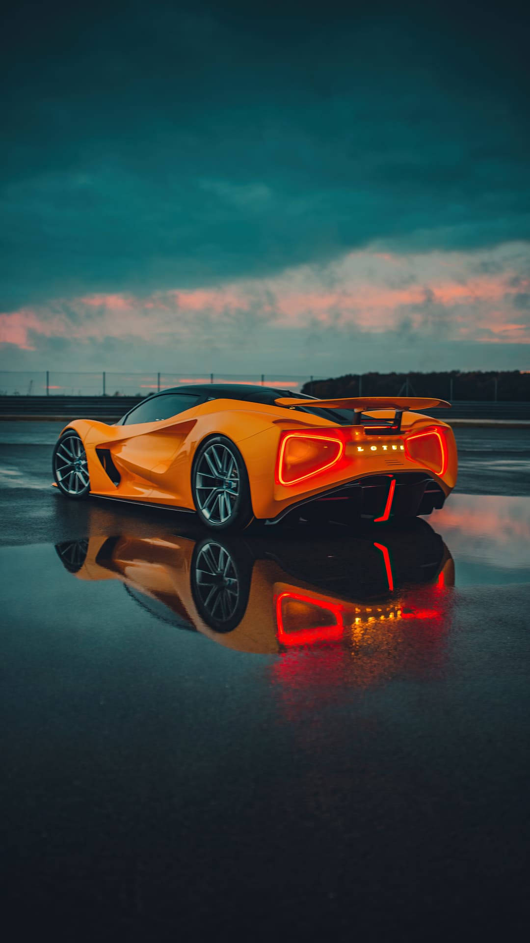 A Futuristic Orange Car Sitting On A Wet Surface Background