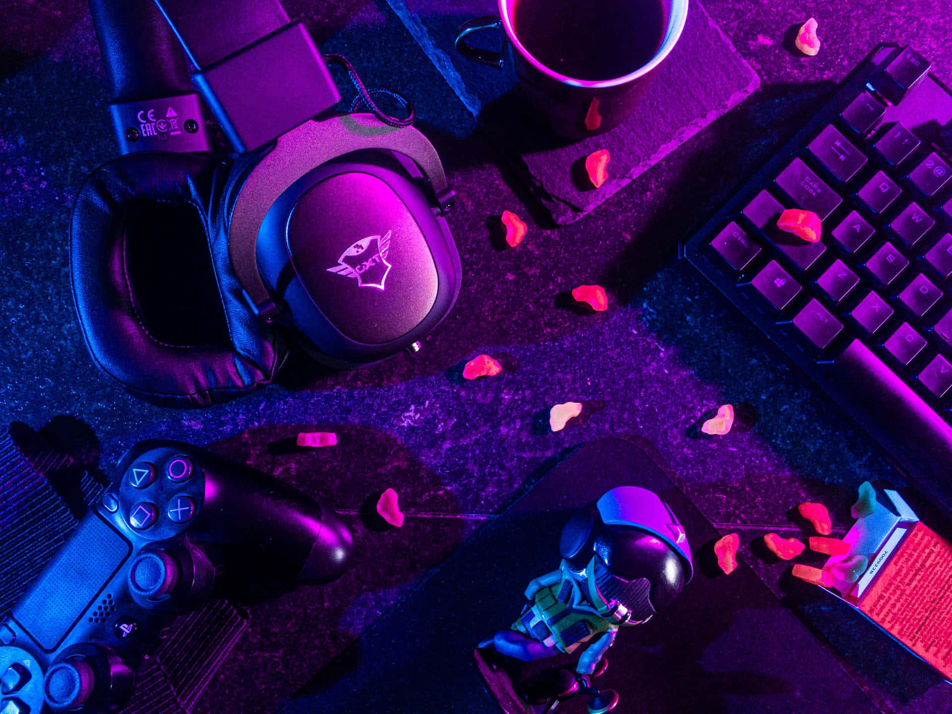 A Gaming Desk With A Mouse, Keyboard, And Headphones Background
