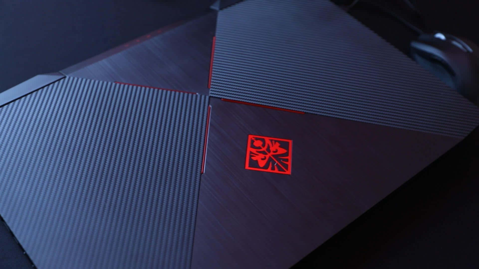 A Gaming Laptop With A Red Light On It Background