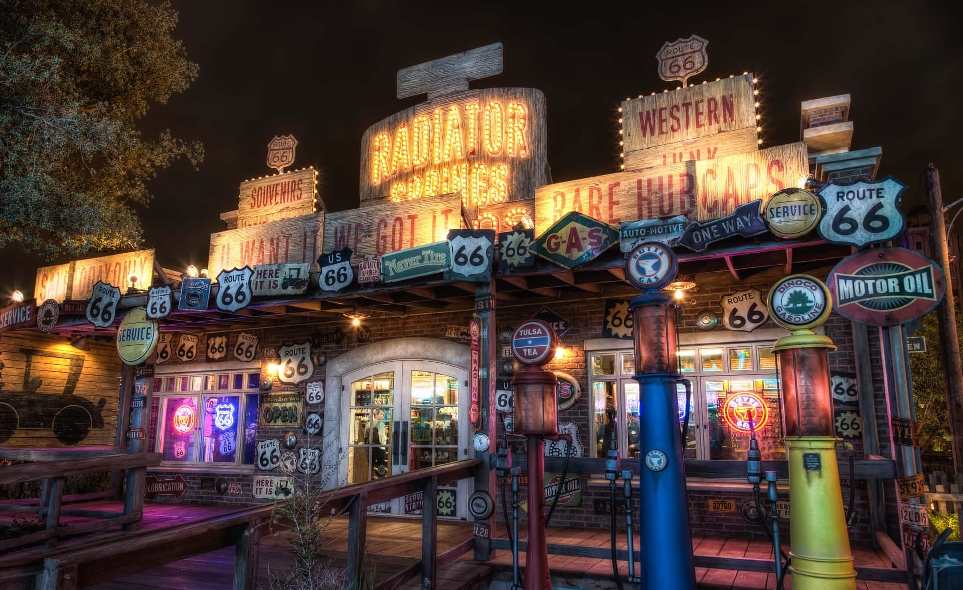 A Gas Station With Many Signs And Lights Background