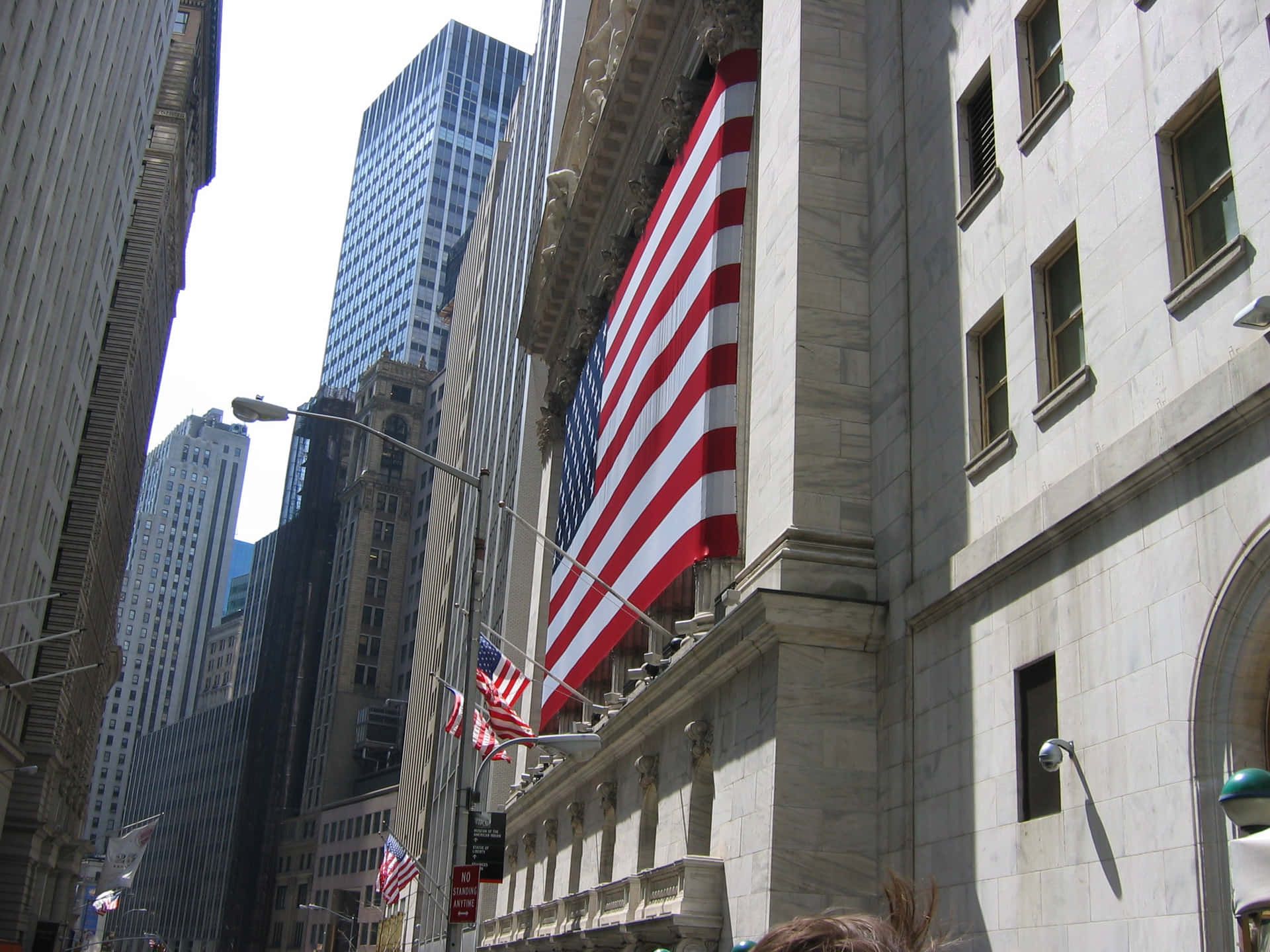 A Giant Wall Street Sign Captures The Spirit Of The Financial District In New York City Background