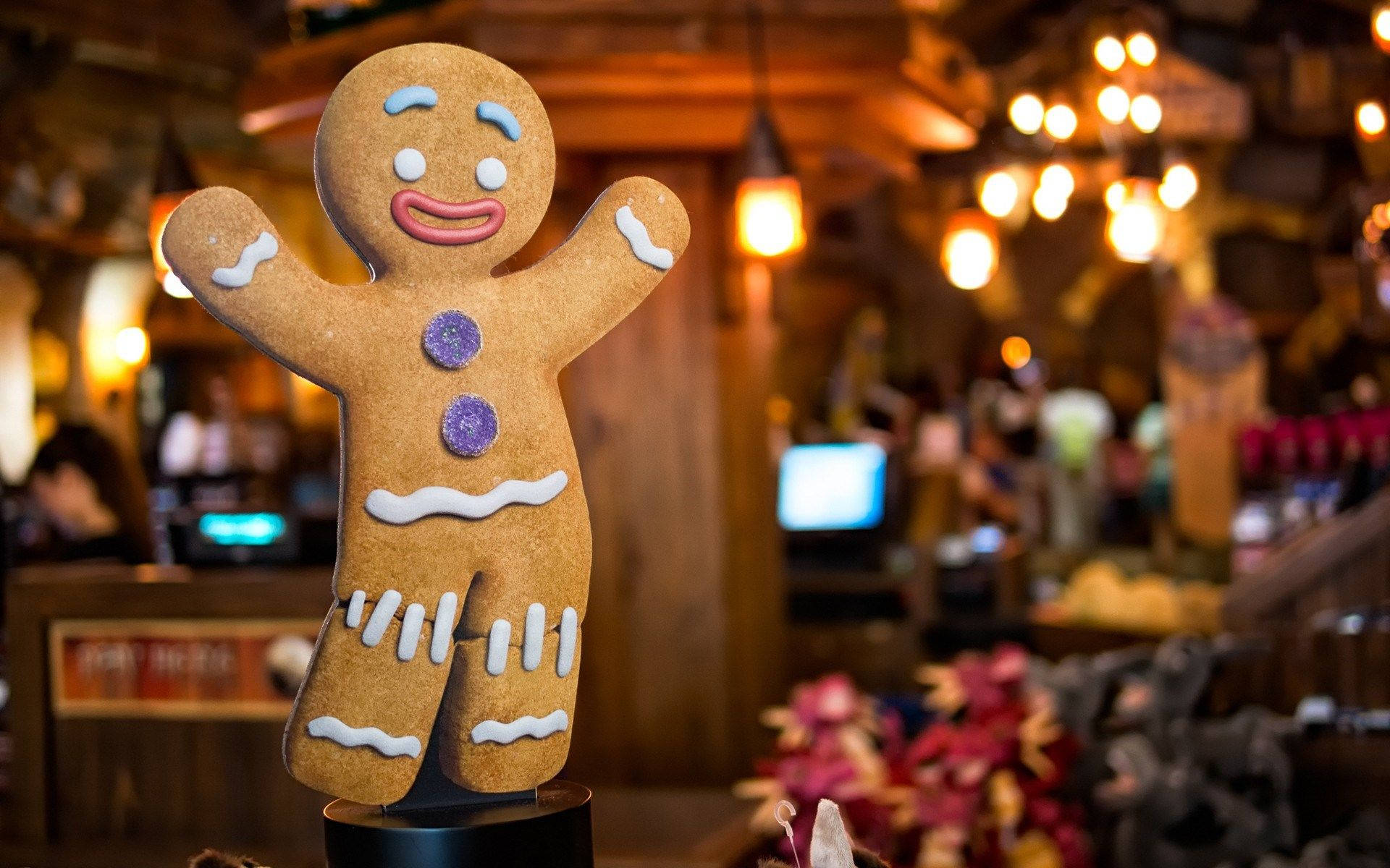 A Gingerbread Man Is Sitting On A Table Background