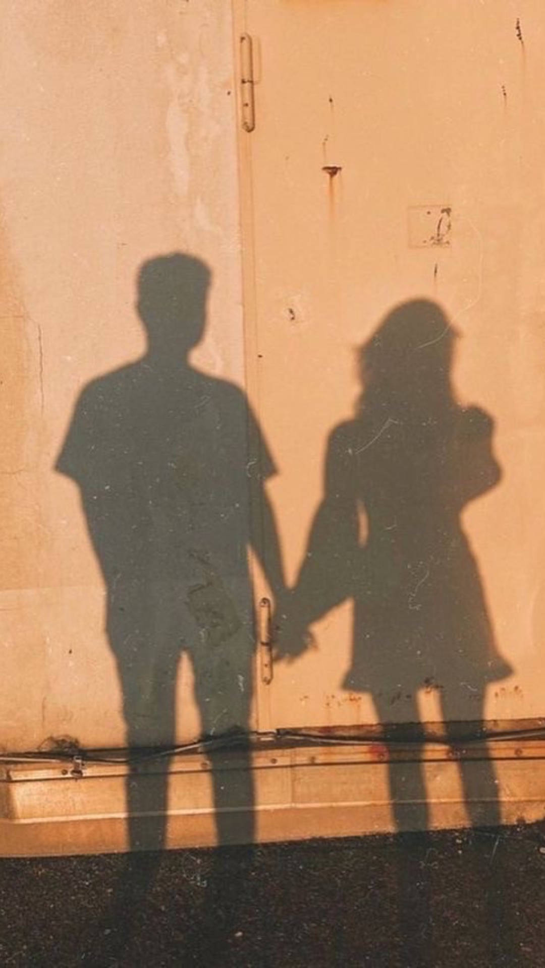 A Girl And Boy Shadow On The Wall