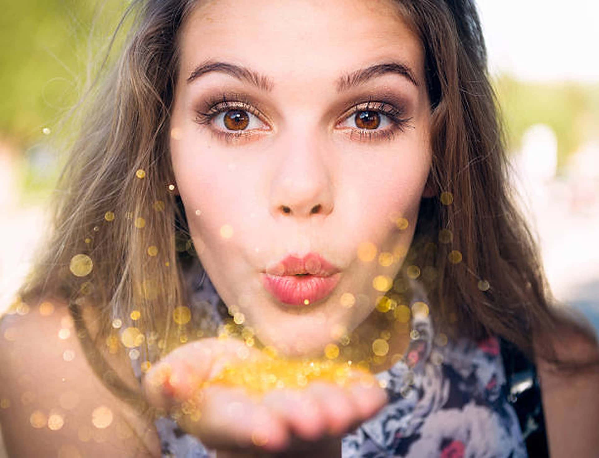 A Girl Blowing A Kiss With Gold Glitter Background