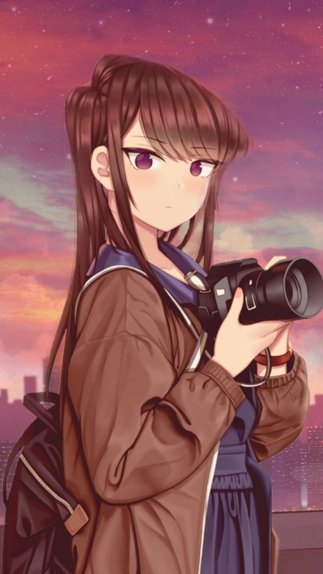 A Girl Holding A Camera In Front Of A Sky Background