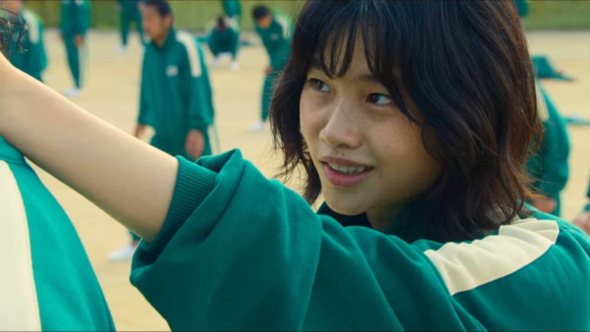 A Girl In Green Uniform Is Putting Her Head On A Girl's Shoulder Background